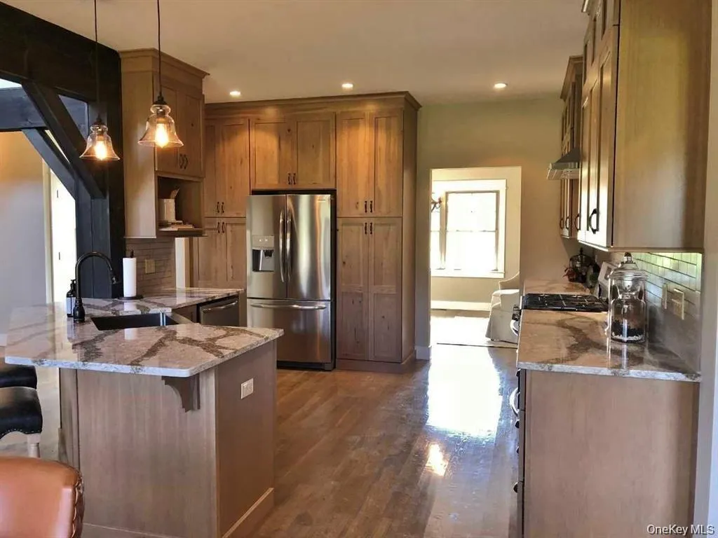An open kitchen layout creates seamless connection to surrounding living spaces. An open kitchen layout creates seamless connection to surrounding living spaces.