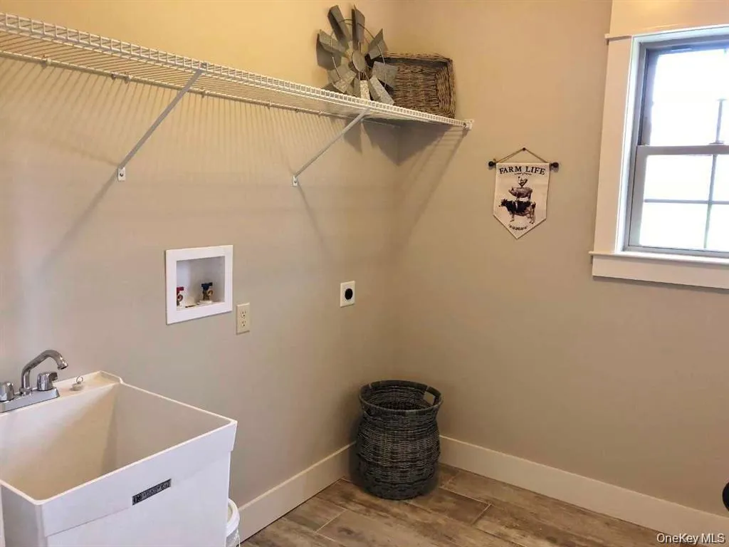 Conveniently located on the lower level, this dedicated laundry room provides a practical and organized space for everyday household tasks while offering easy access to the family room, garage, and lower-level living areas. Conveniently located on the lower level, this dedicated laundry room provides a practical and organized space for everyday household tasks while offering easy access to the family room, garage, and lower-level living areas.
