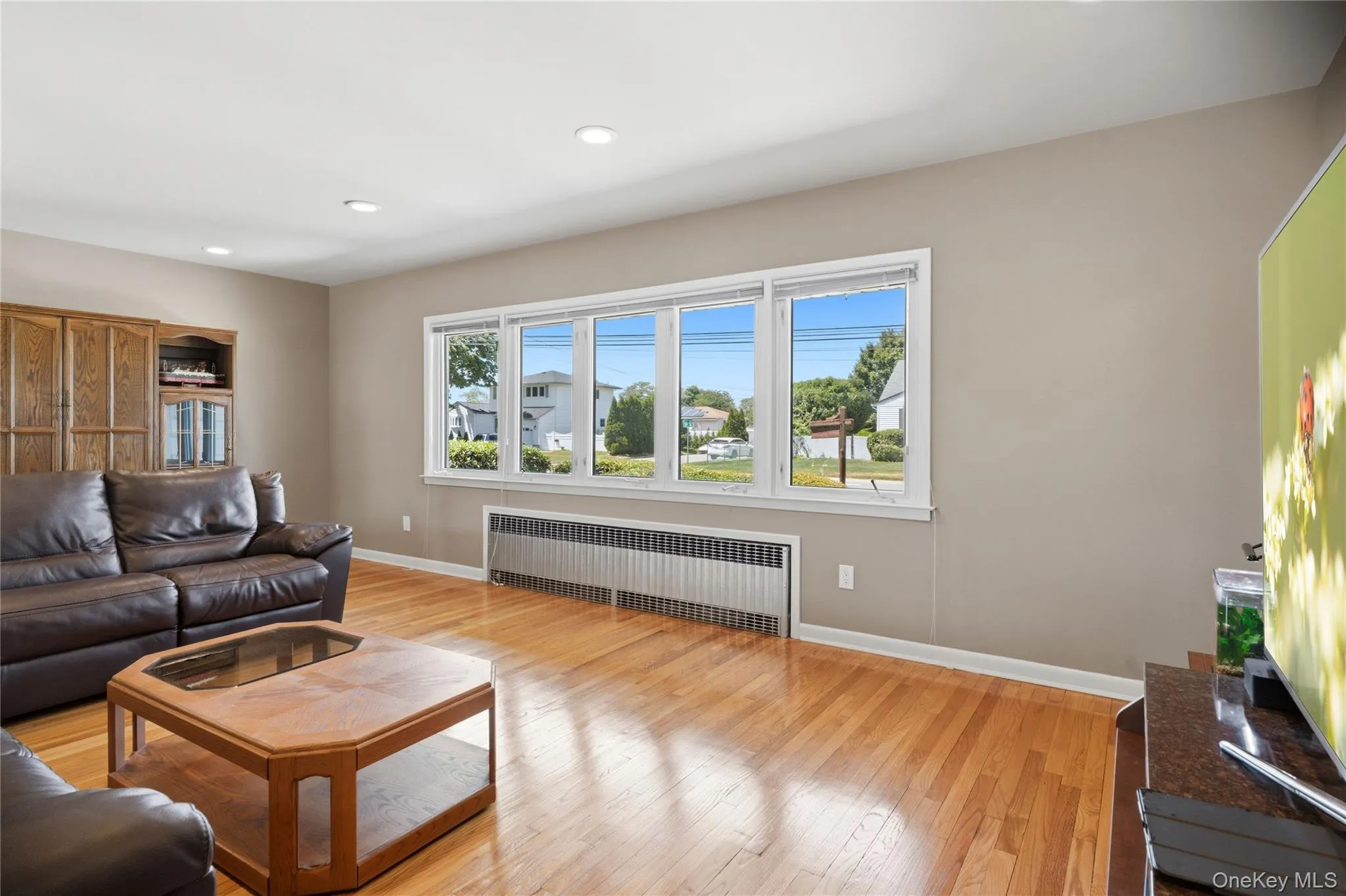 Hardwood flooring complements a neutral wall palette, creating an inviting living space Hardwood flooring complements a neutral wall palette, creating an inviting living space