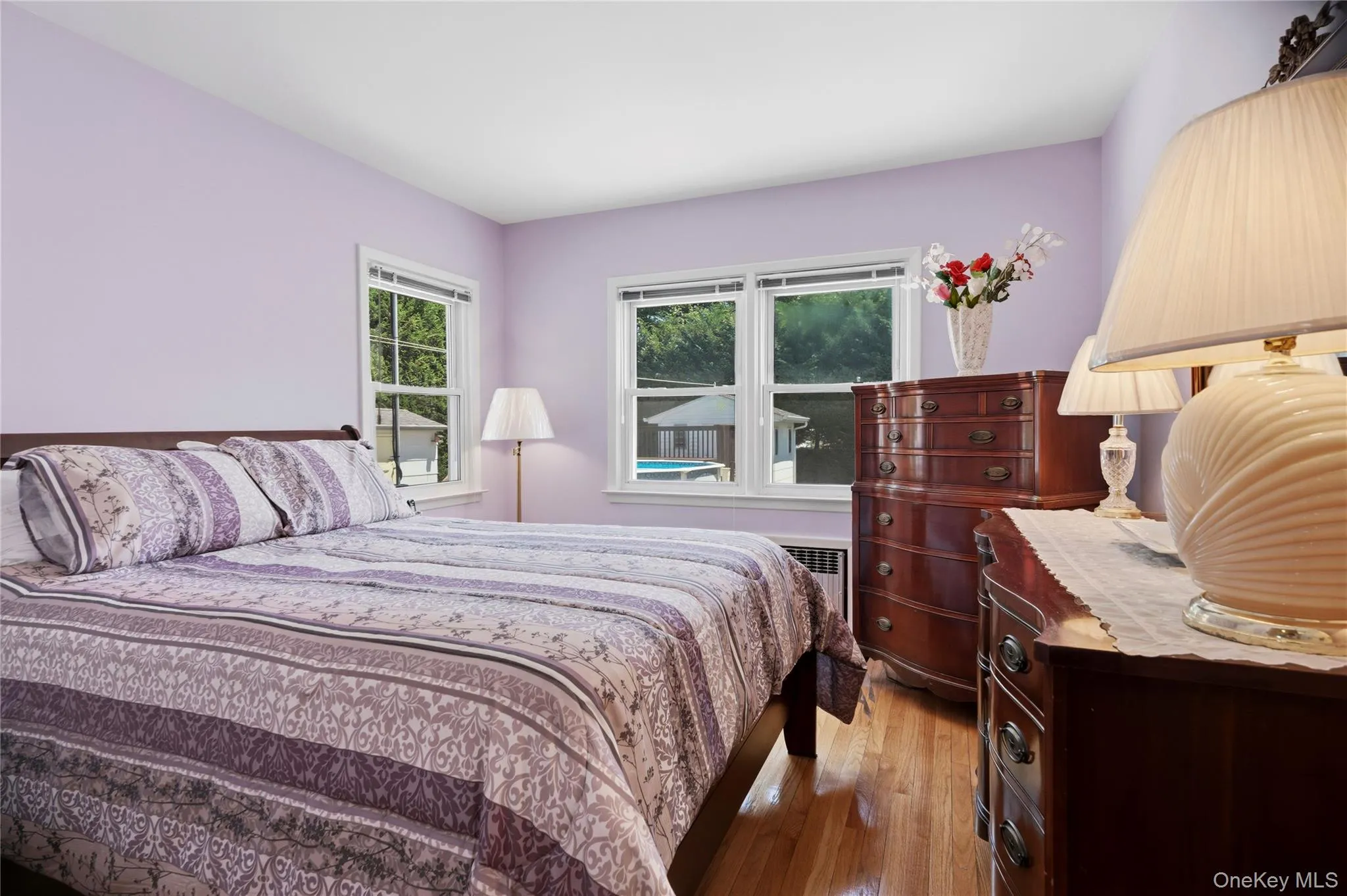 Hardwood flooring complements the light purple walls Hardwood flooring complements the light purple walls