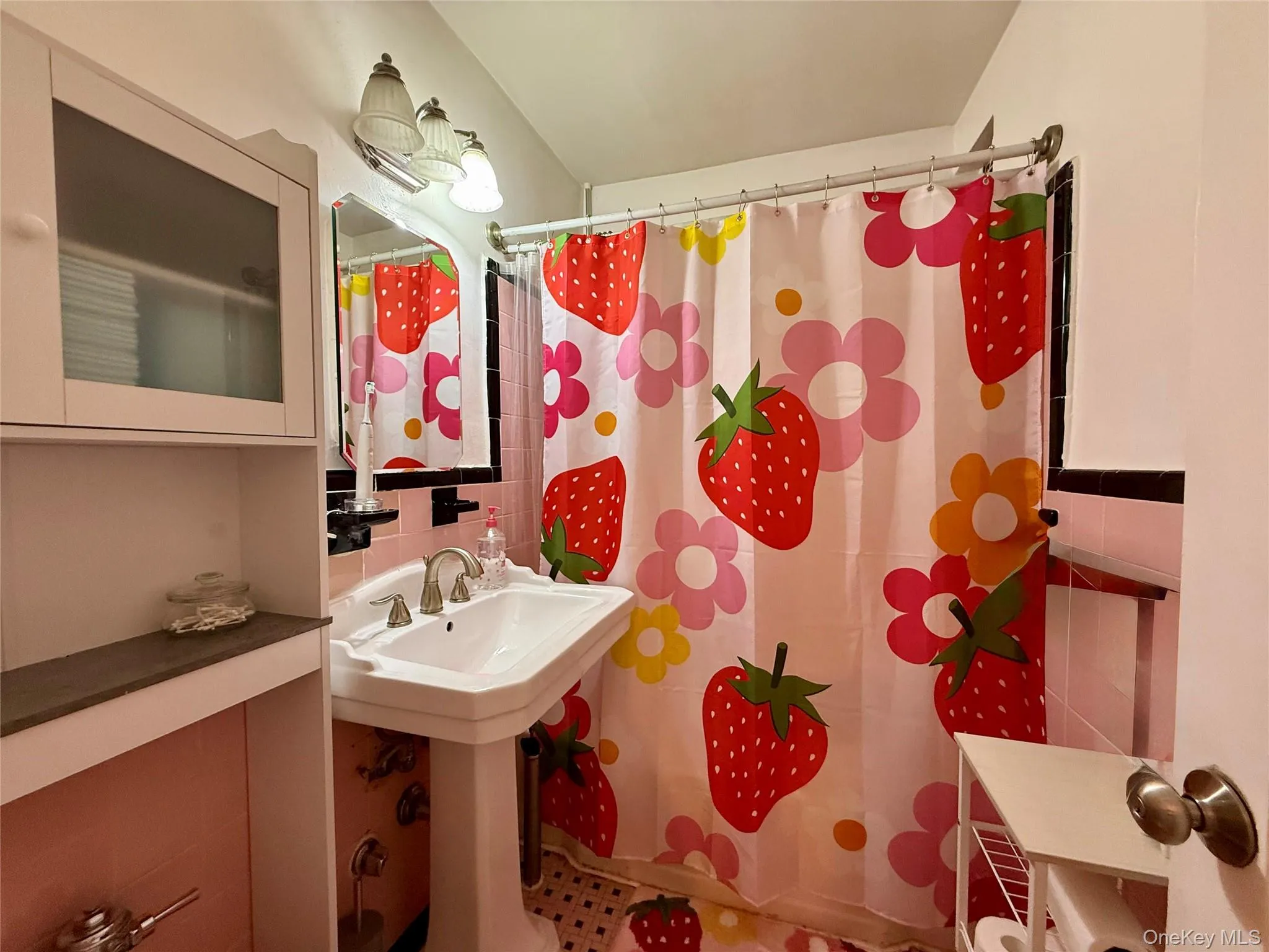Pedestal sink with dual handle faucet, vanity mirror, and overhead lighting, window for ventilation. Pedestal sink with dual handle faucet, vanity mirror, and overhead lighting, window for ventilation.
