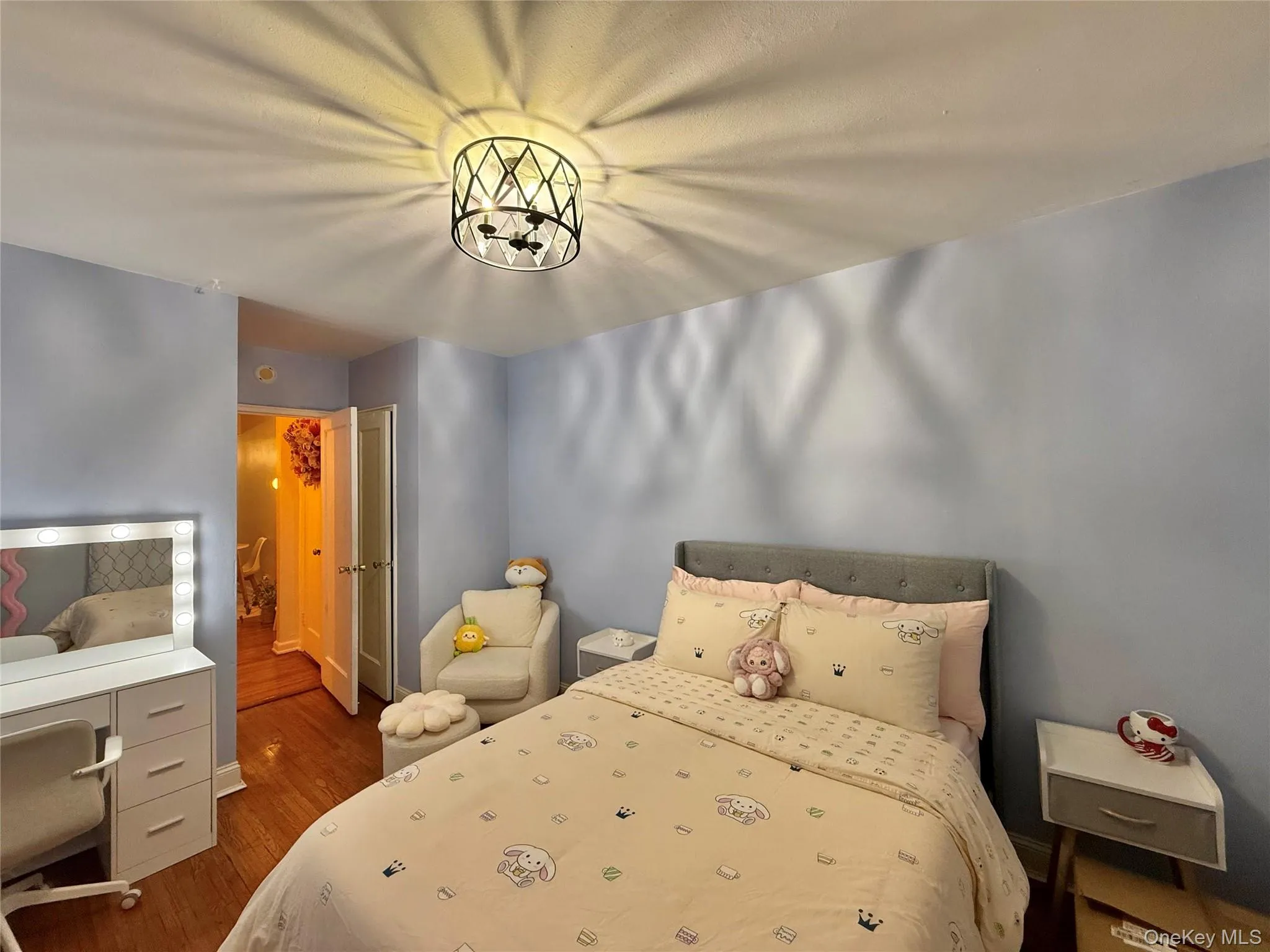 Second bedroom with hardwood flooring, a large window, a closet. Second bedroom with hardwood flooring, a large window, a closet.