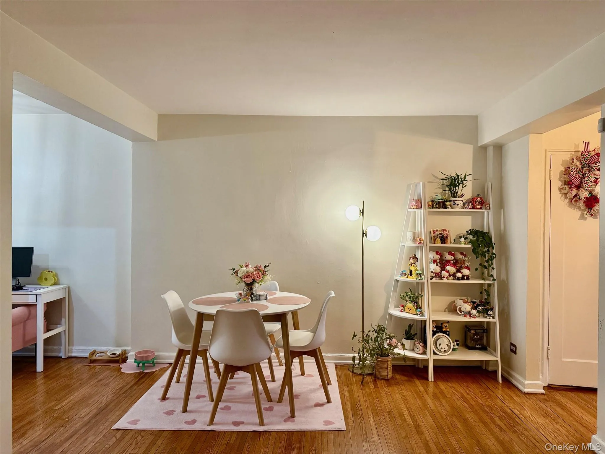 Dining area open to the living room with hardwood flooring extending throughout the space Dining area open to the living room with hardwood flooring extending throughout the space
