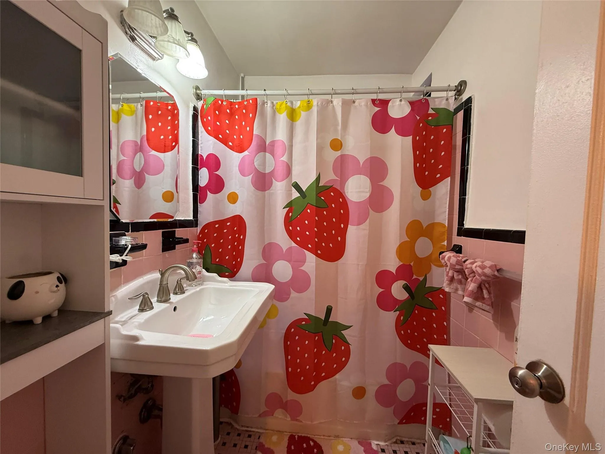 Pedestal sink with dual handle faucet, vanity mirror, and overhead lighting, window for ventilation. Pedestal sink with dual handle faucet, vanity mirror, and overhead lighting, window for ventilation.