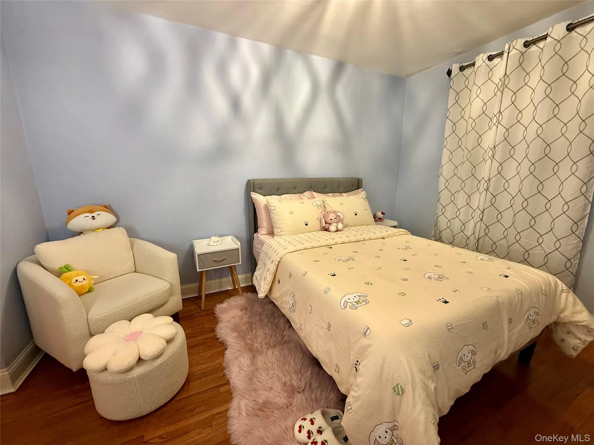 Second bedroom with hardwood flooring, a large window, a closet. Second bedroom with hardwood flooring, a large window, a closet.