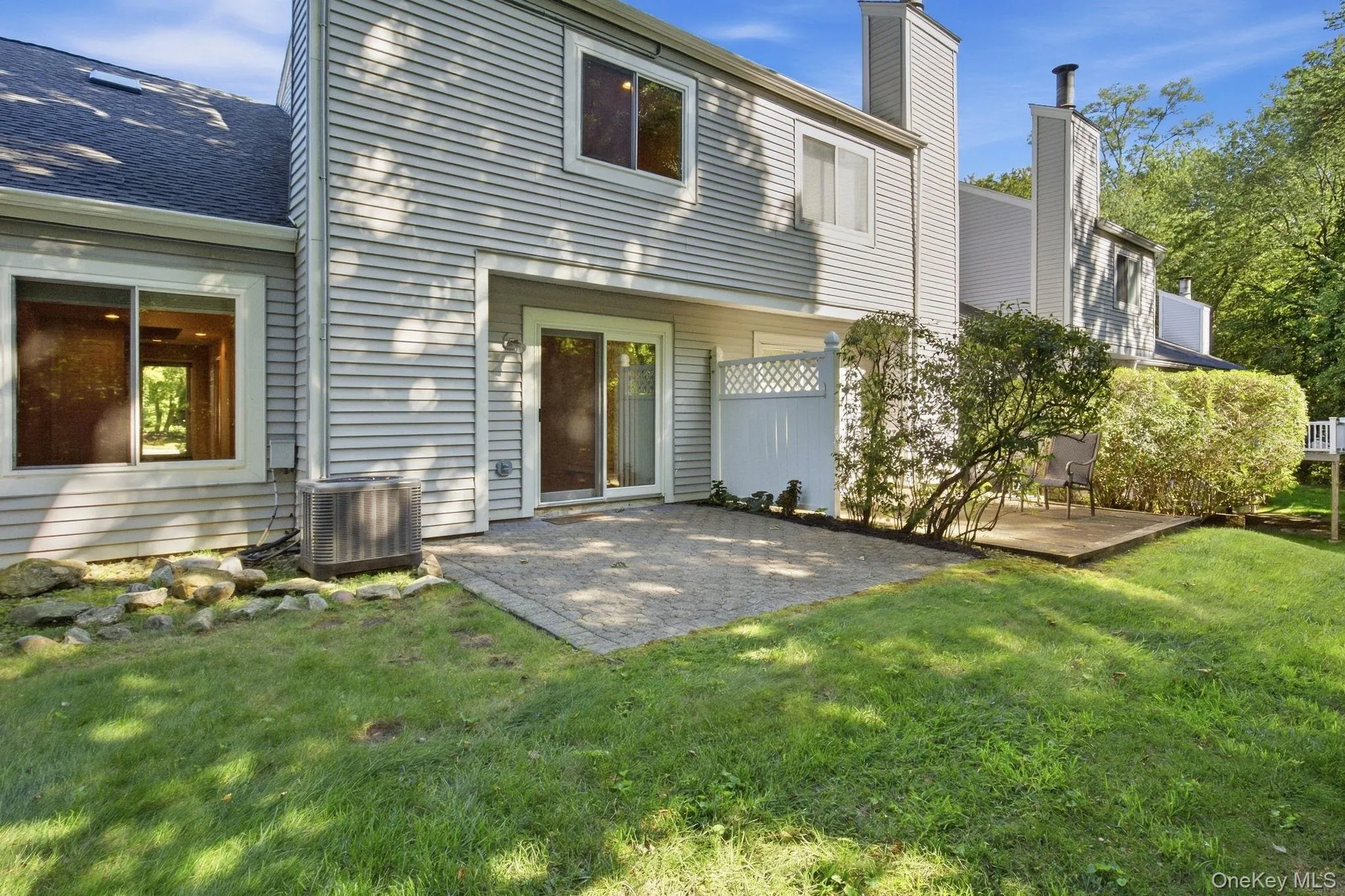 Patio is bordered by privacy fencing and mature landscaping. Patio is bordered by privacy fencing and mature landscaping.