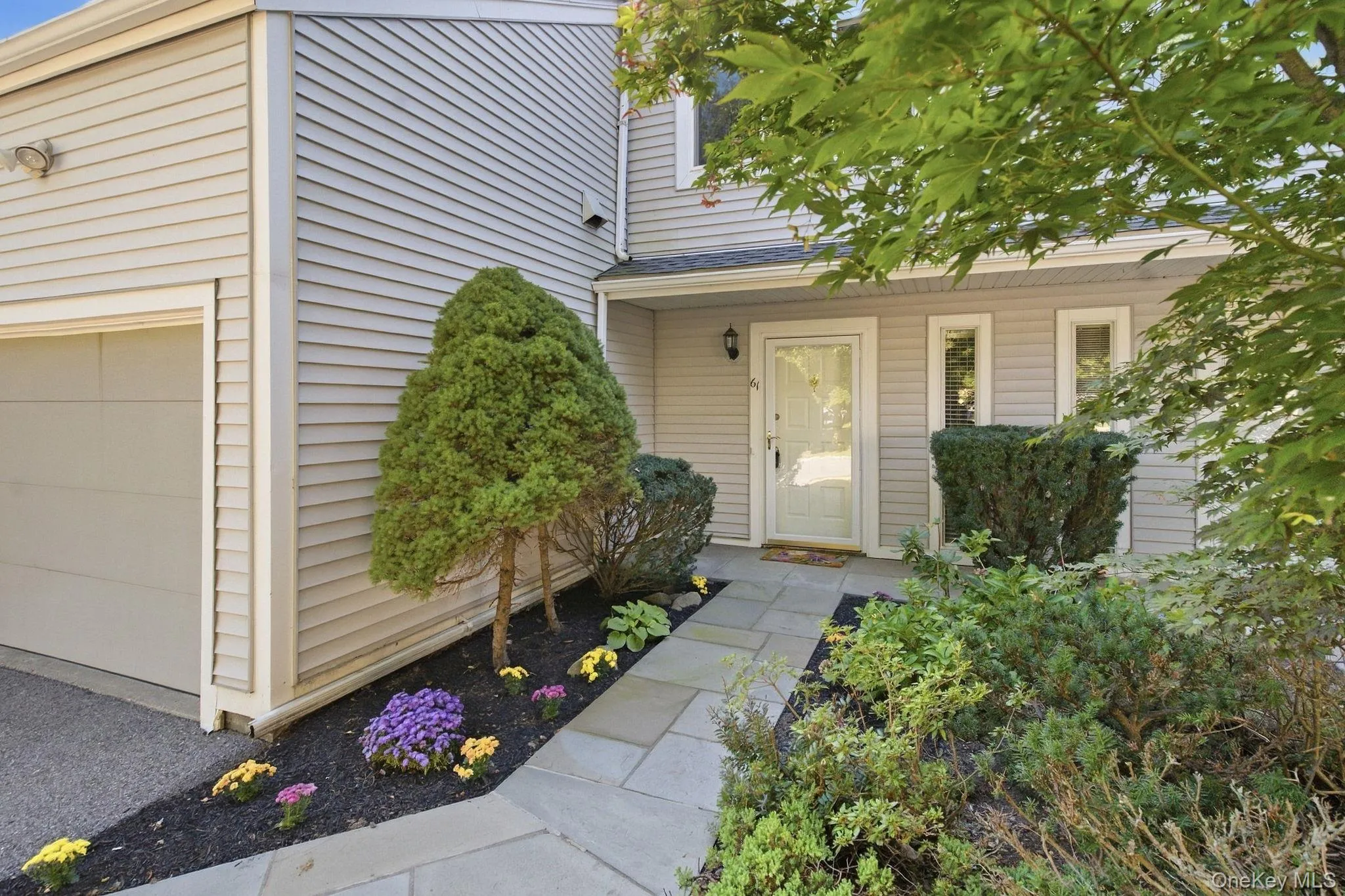Established shrubs and plantings add greenery and privacy around the entrance. Established shrubs and plantings add greenery and privacy around the entrance.