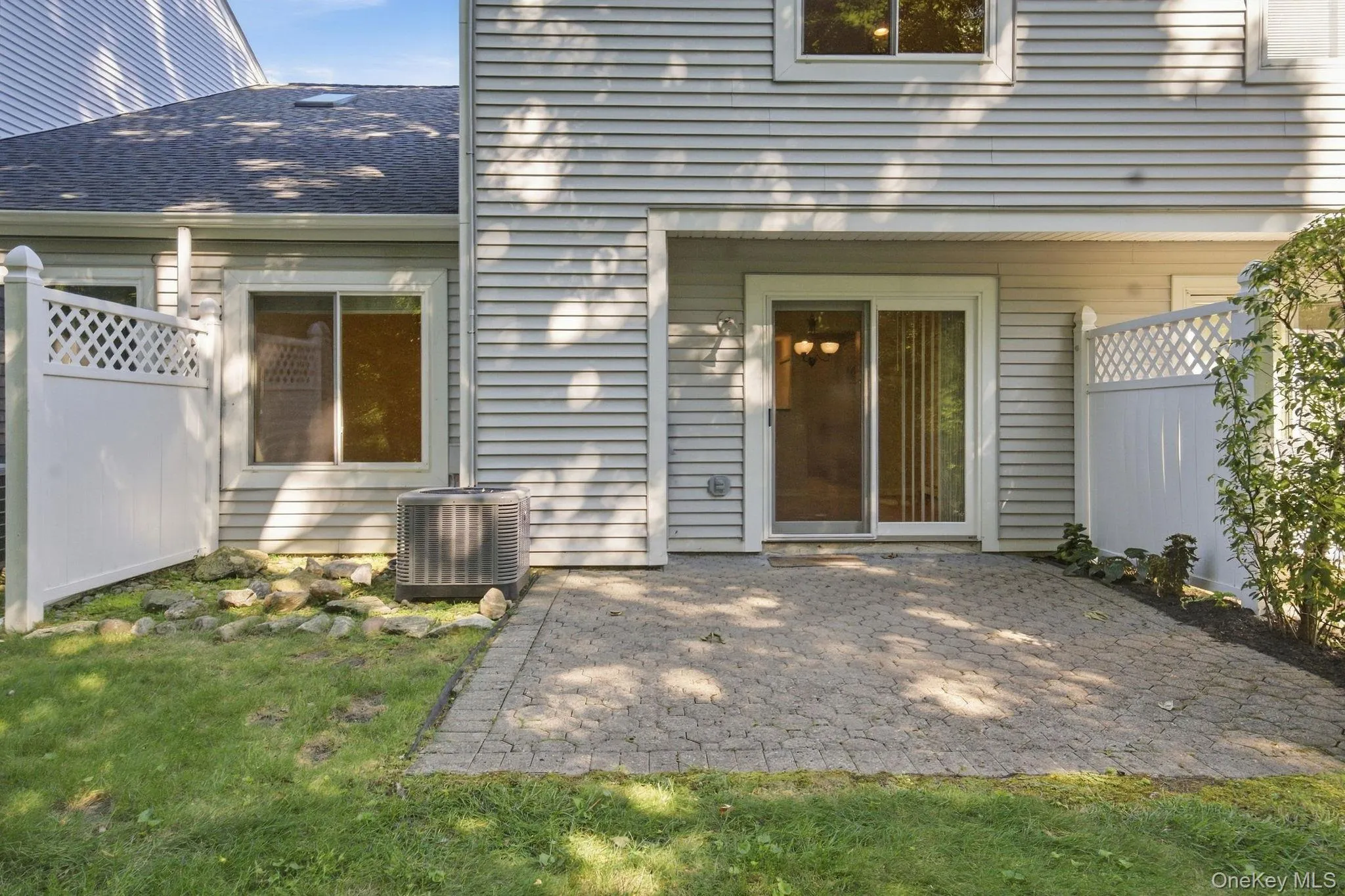 Rear exterior shows the patio’s connection to the home and surrounding lawn. Rear exterior shows the patio’s connection to the home and surrounding lawn.