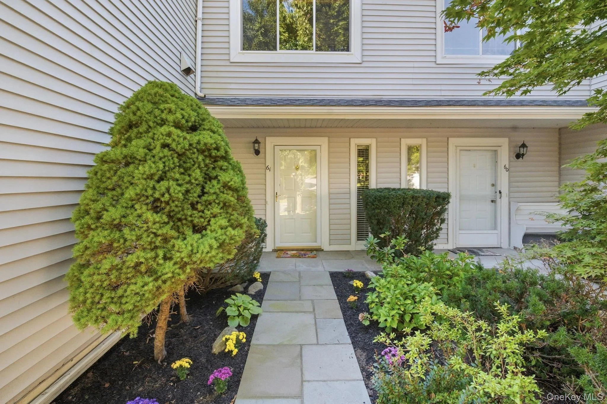 Landscaped walkway leads from the driveway to the covered front entry. Landscaped walkway leads from the driveway to the covered front entry.