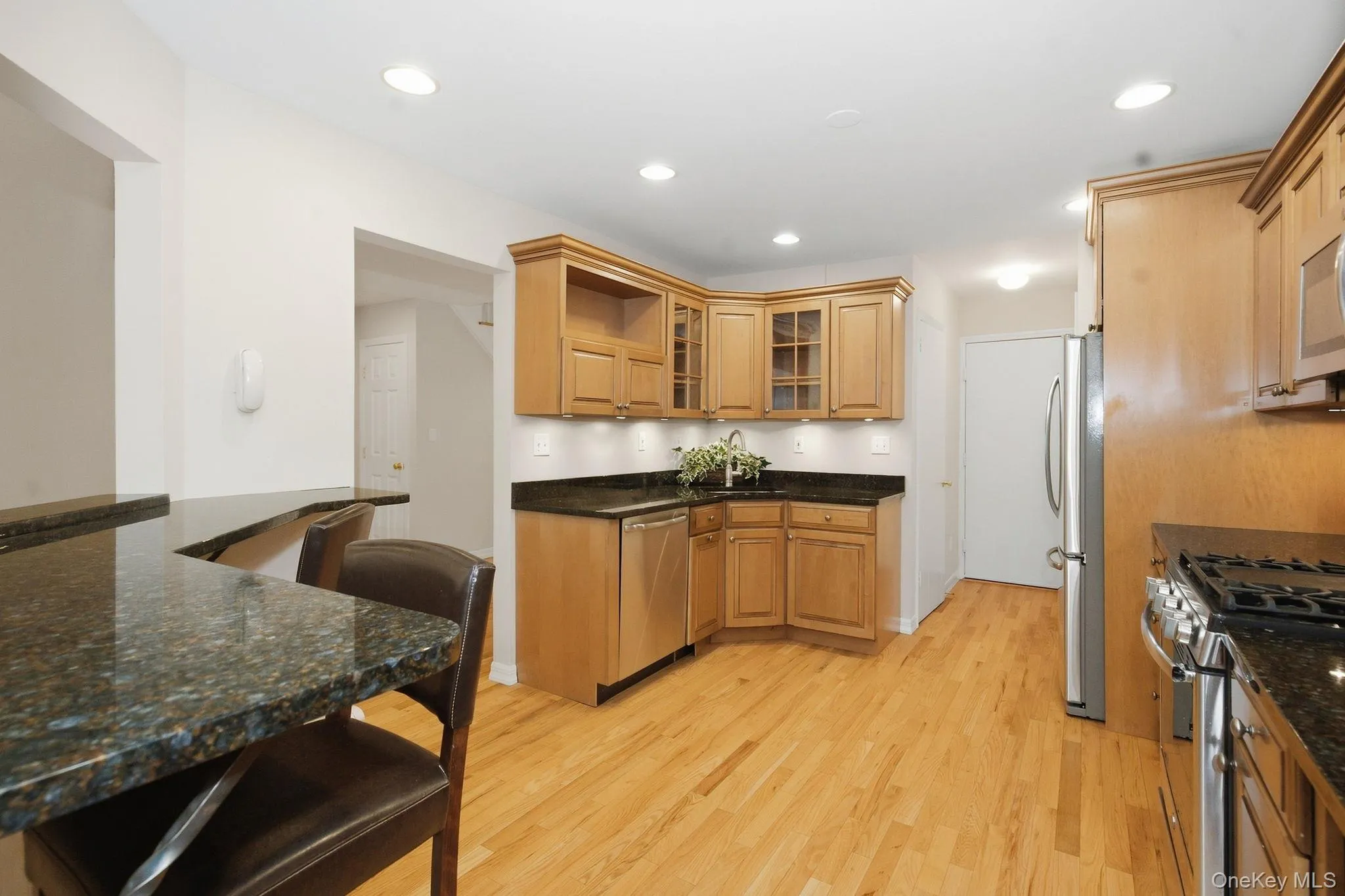 Ample cabinetry and an extended stretch of granite provide generous kitchen storage and workspace. Ample cabinetry and an extended stretch of granite provide generous kitchen storage and workspace.