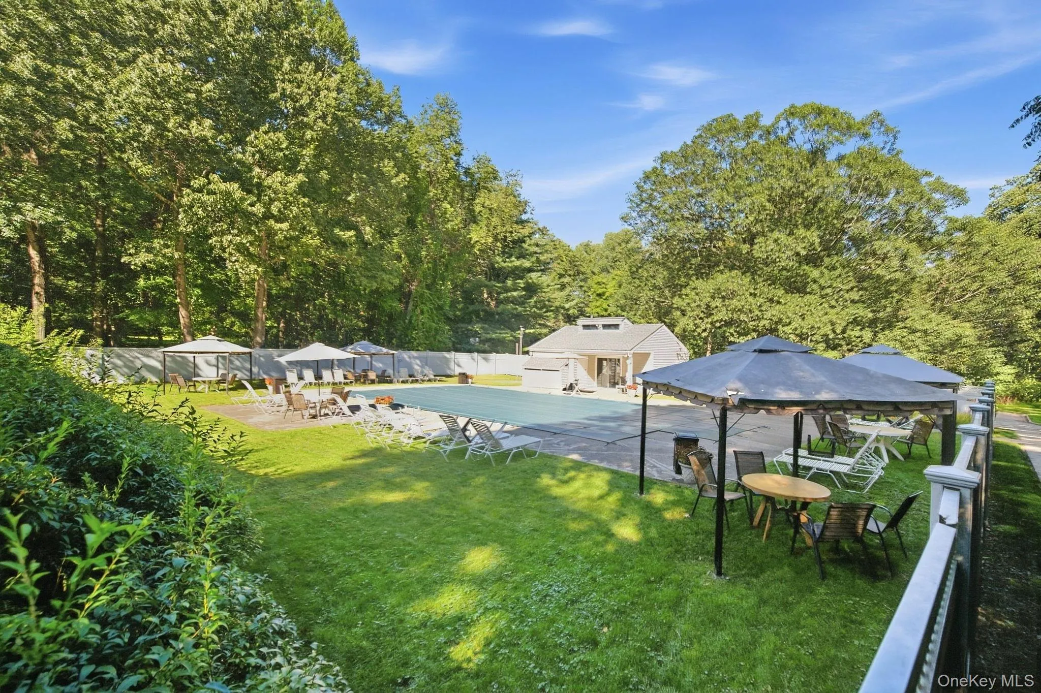 Community pool area includes surrounding patio space for residents. Community pool area includes surrounding patio space for residents.