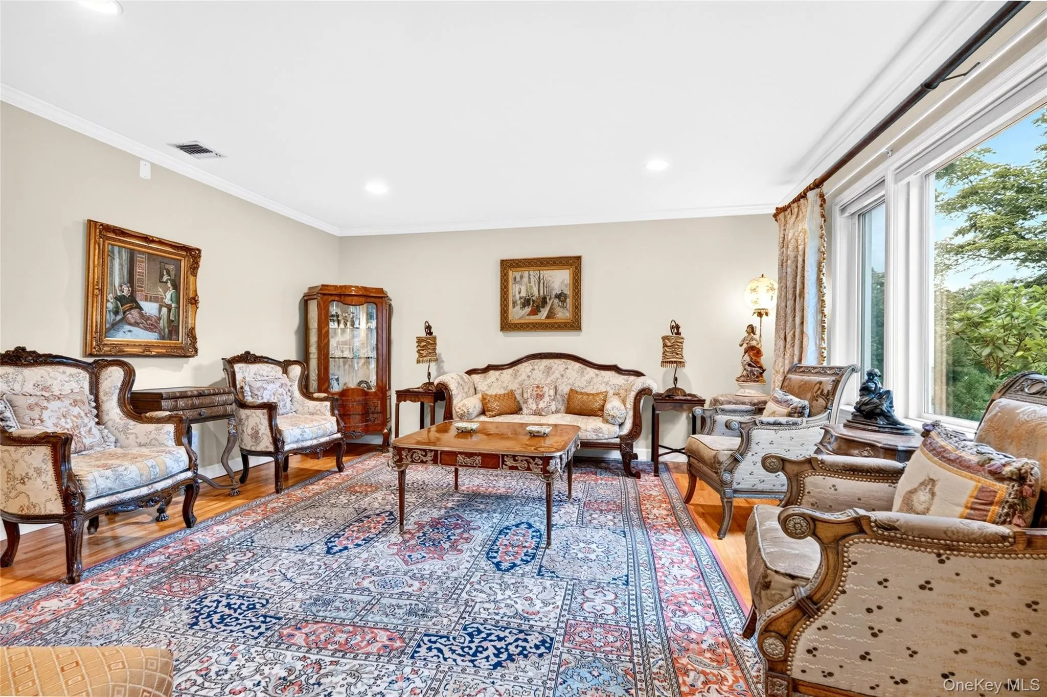 Hardwood flooring, recessed lighting, crown molding, and large windows Hardwood flooring, recessed lighting, crown molding, and large windows