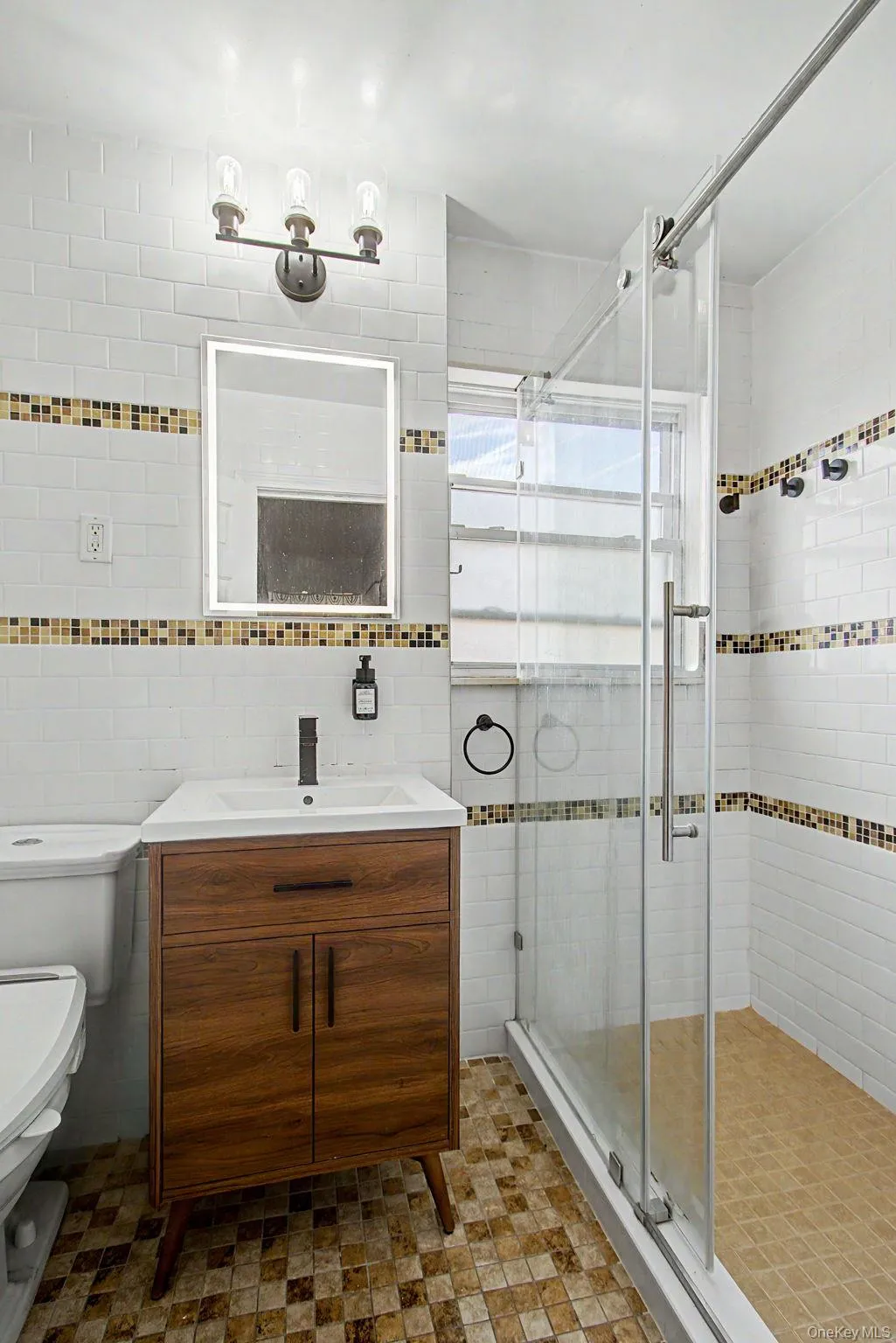 Bathroom featuring a mid-century modern style vanity with an integrated sink, matte black faucet, and an illuminated mirror Bathroom featuring a mid-century modern style vanity with an integrated sink, matte black faucet, and an illuminated mirror
