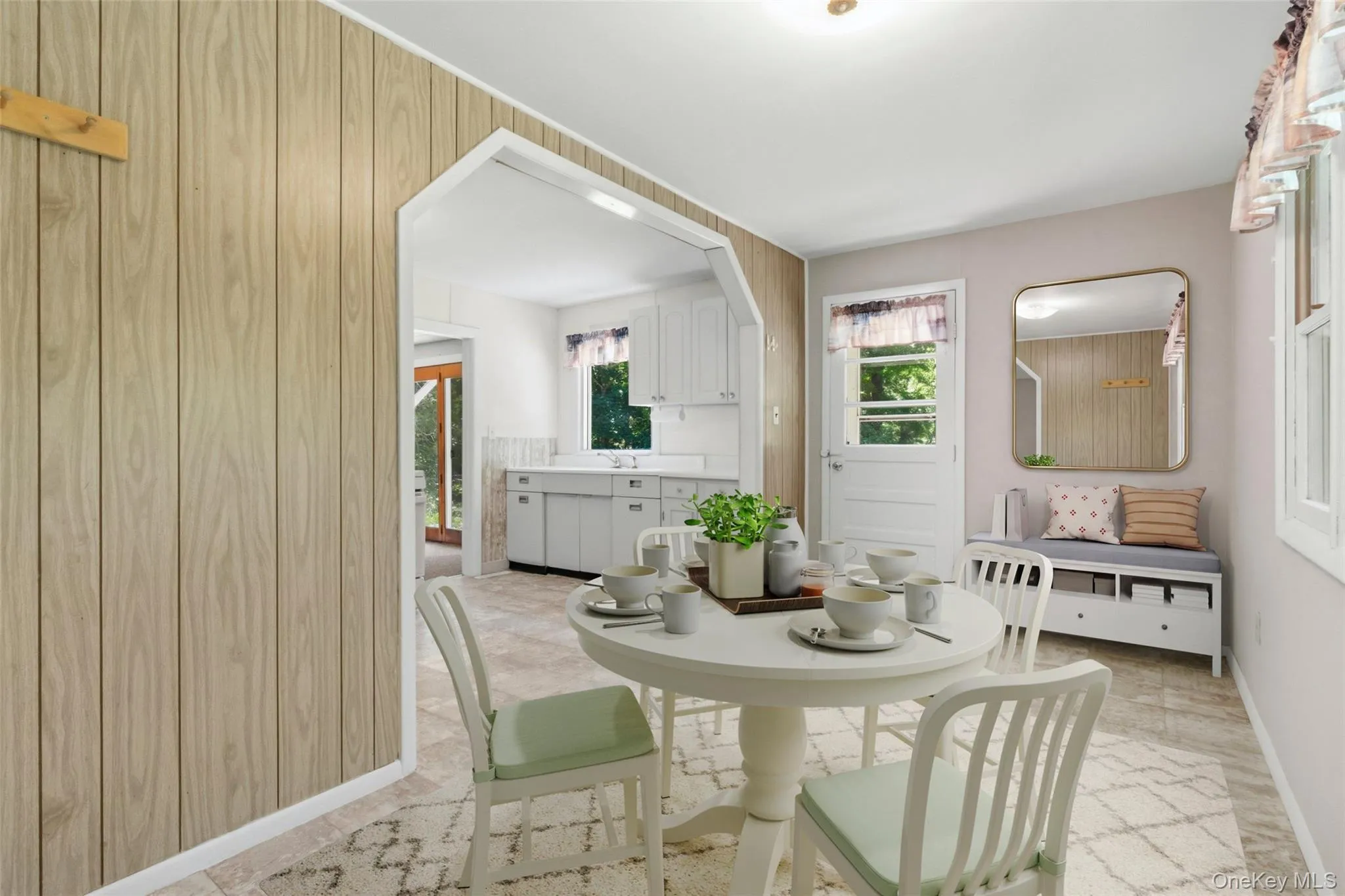 Virtually Staged for Inspo.Private Entrance to Dining area featuring wood-finish paneling, an arched doorway to the kitchen along with double doors to a large patio. Virtually Staged for Inspo.Private Entrance to Dining area featuring wood-finish paneling, an arched doorway to the kitchen along with double doors to a large patio.