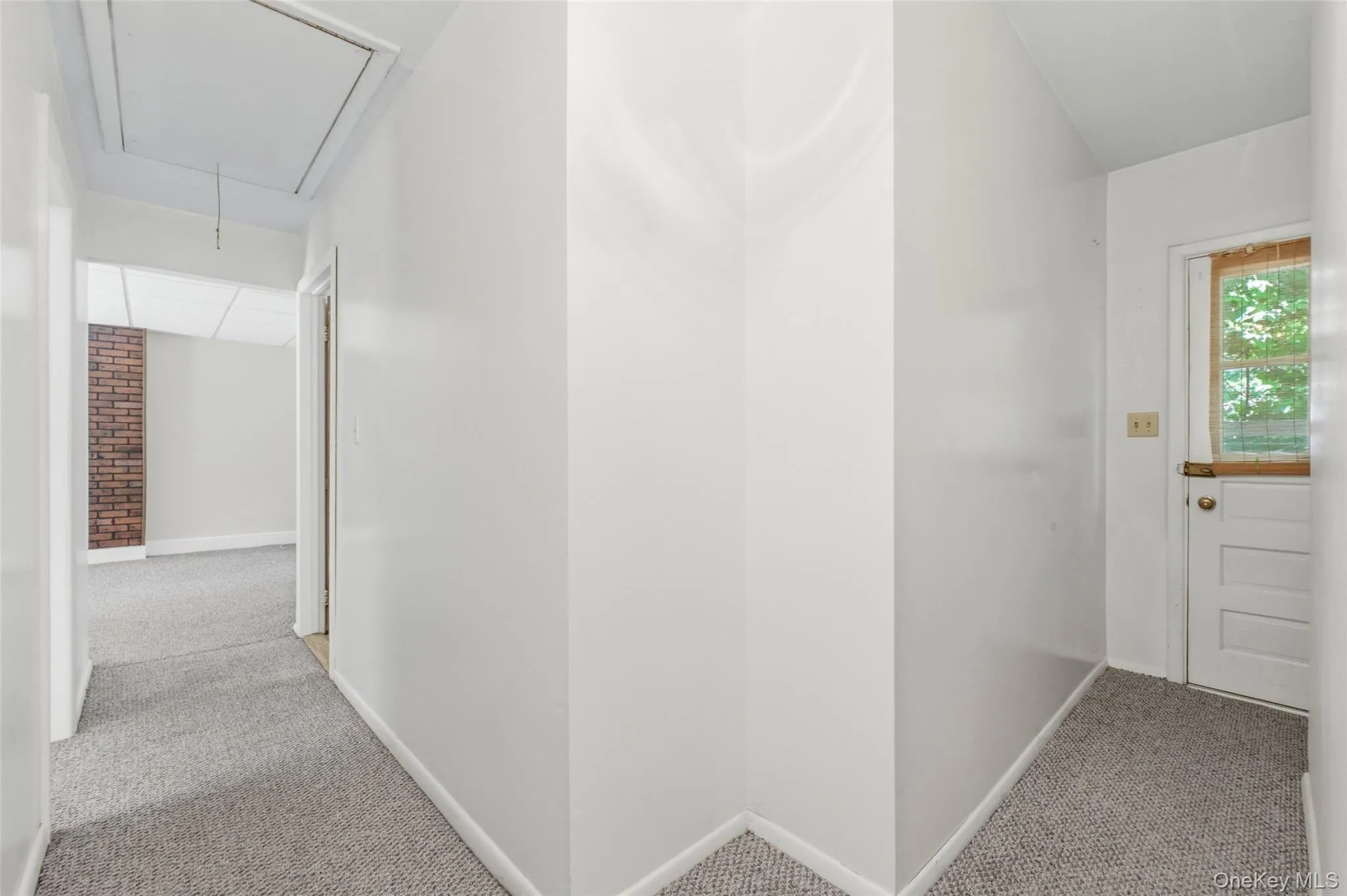 Hallway leading to Bedrooms and Private Access to Laundry room in basement Hallway leading to Bedrooms and Private Access to Laundry room in basement