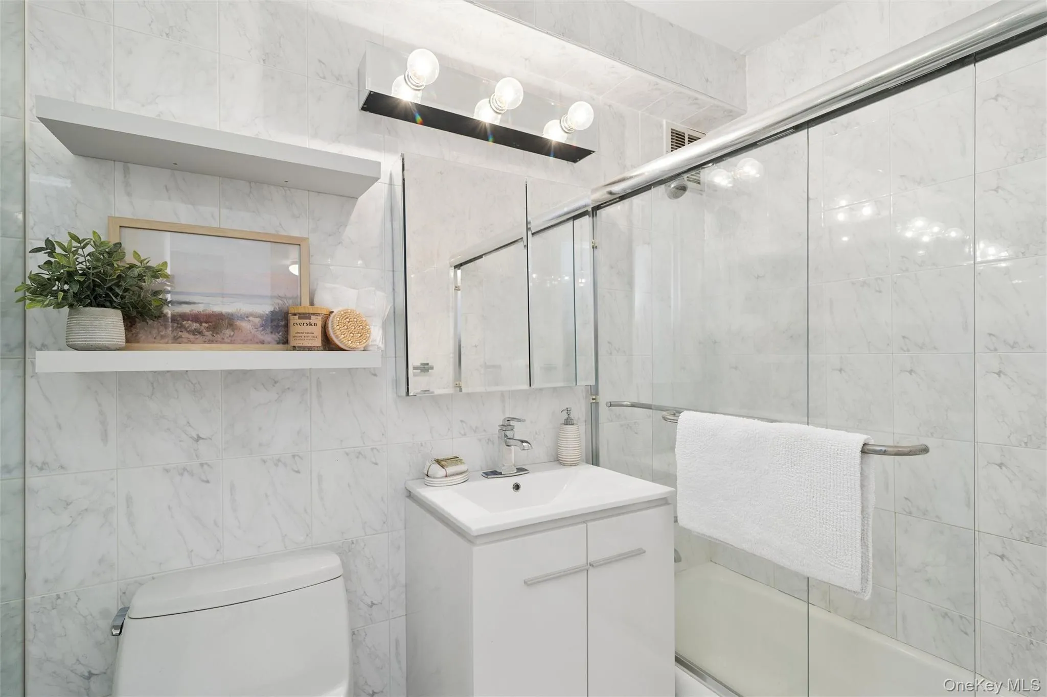 Updated bathroom with glass shower doors Updated bathroom with glass shower doors
