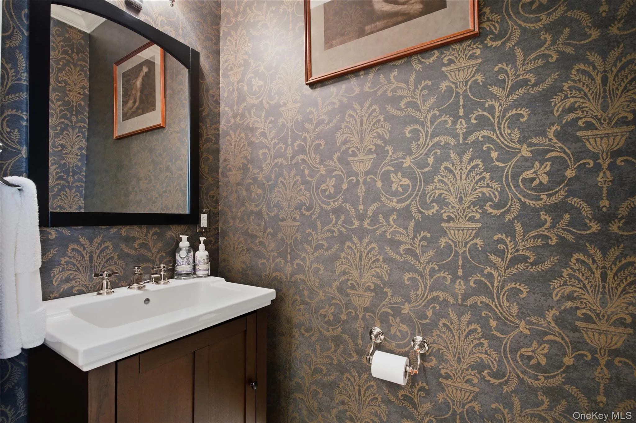 Stylish powder room featuring designer wall-paper and tasteful finishes. Stylish powder room featuring designer wall-paper and tasteful finishes.