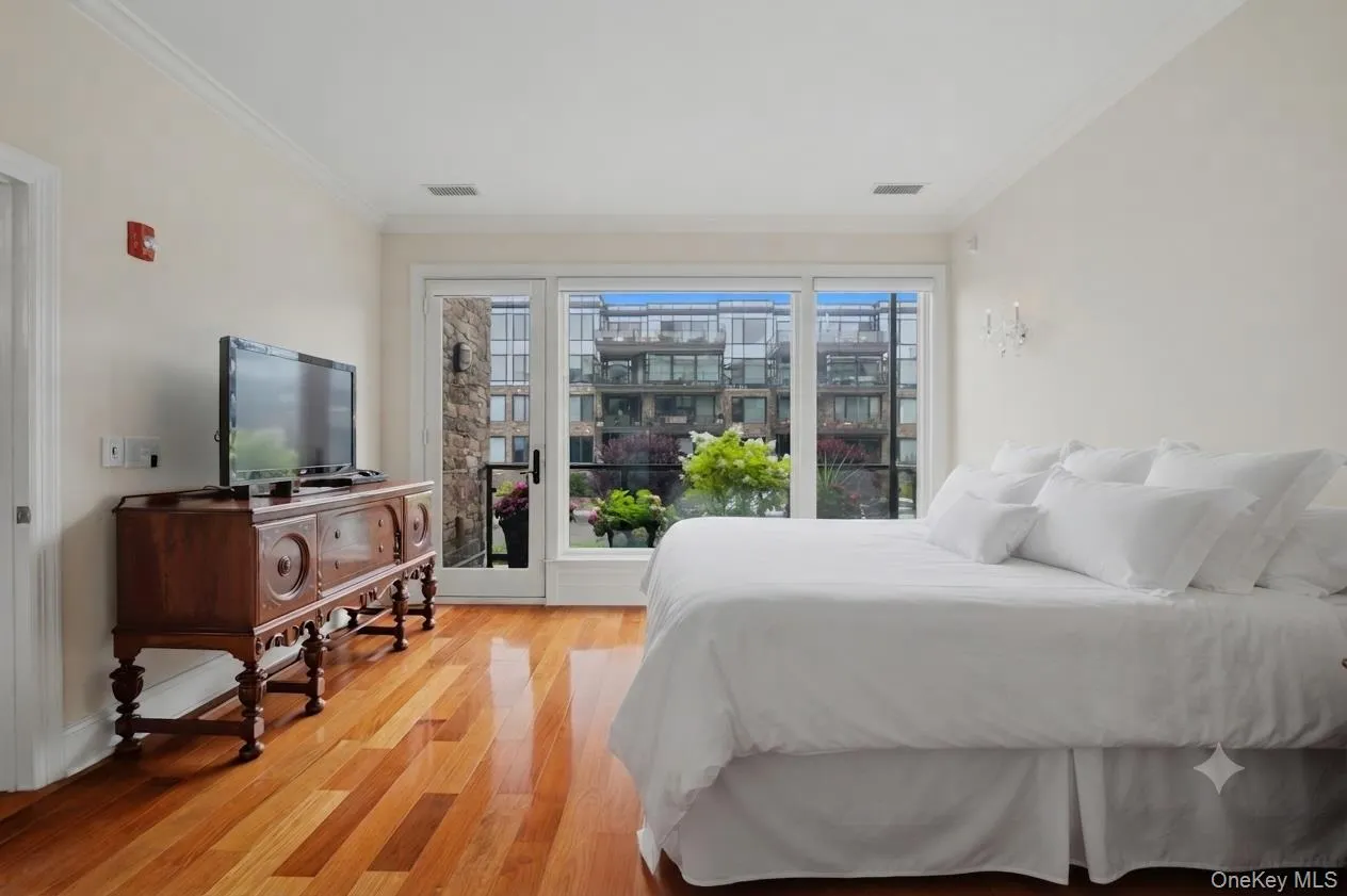 Spacious primary suite with a large private balcony showcasing beautiful views. (Bedding was virtually staged) Spacious primary suite with a large private balcony showcasing beautiful views. (Bedding was virtually staged)