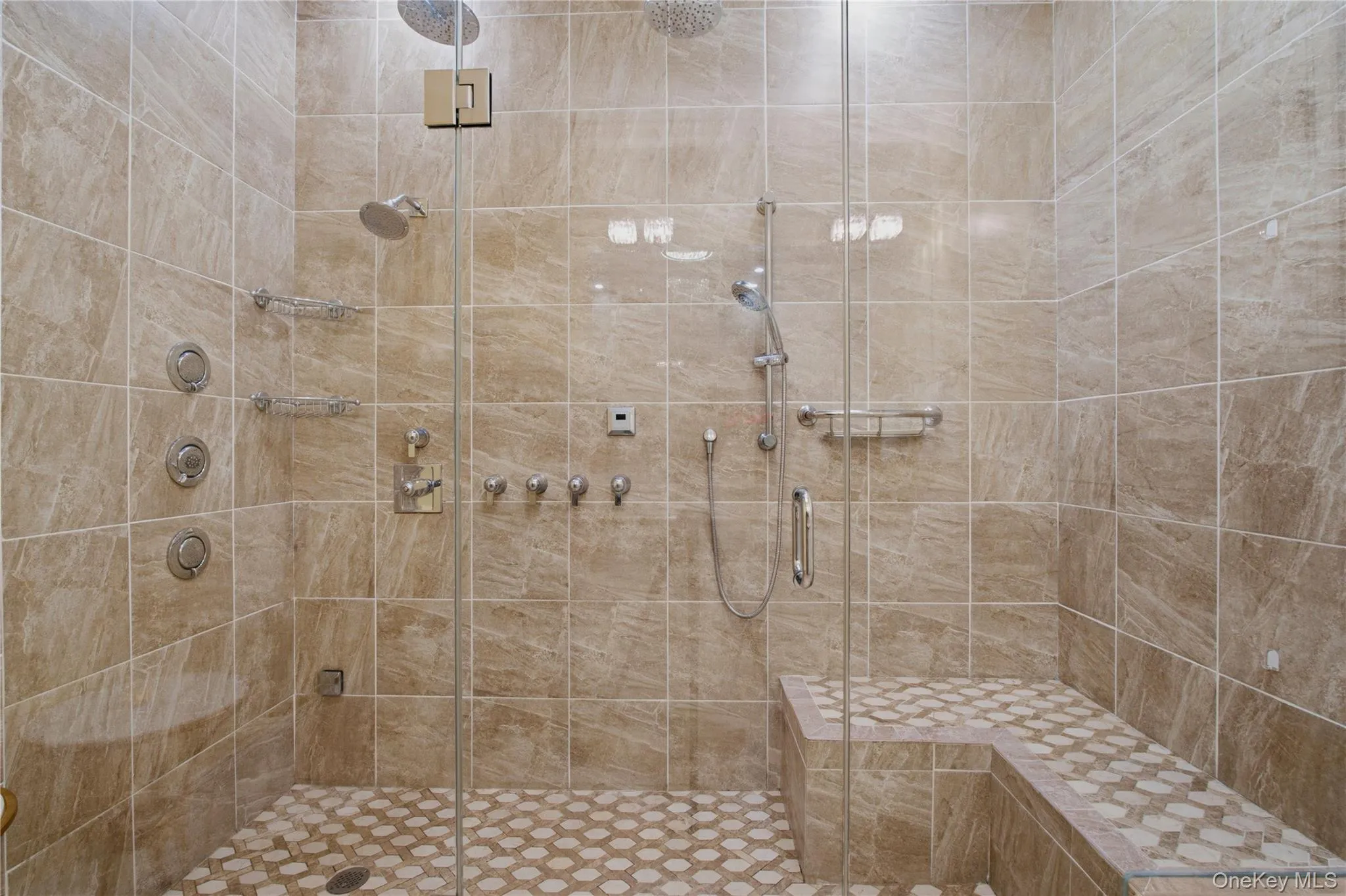 Close-up of the oversized spa-inspired shower showcasing elegant tile work and sleek modern finishes. Close-up of the oversized spa-inspired shower showcasing elegant tile work and sleek modern finishes.