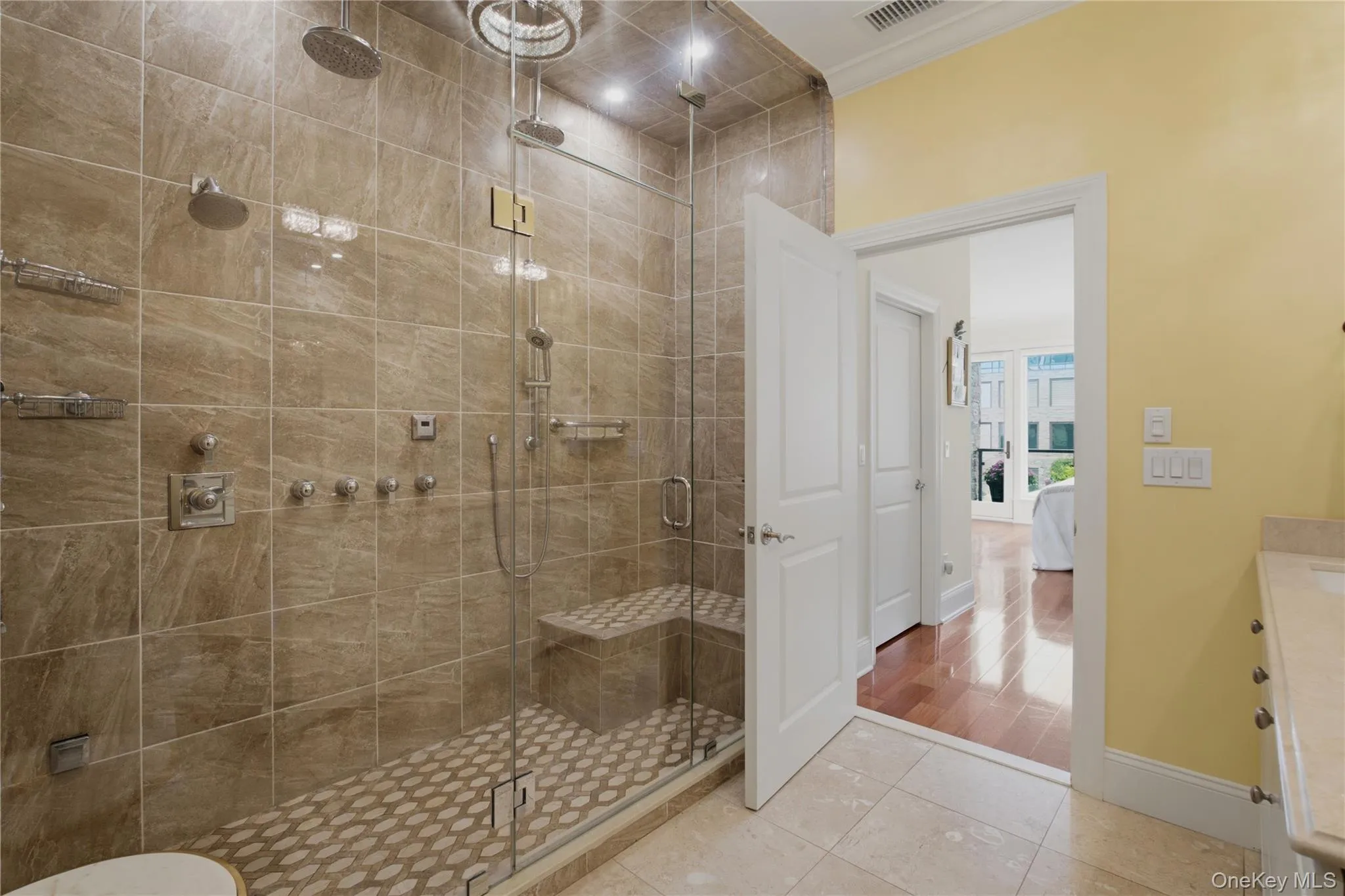Luxurious primary bath featuring a spacious spa-inspired shower with sleek modern finishes Luxurious primary bath featuring a spacious spa-inspired shower with sleek modern finishes