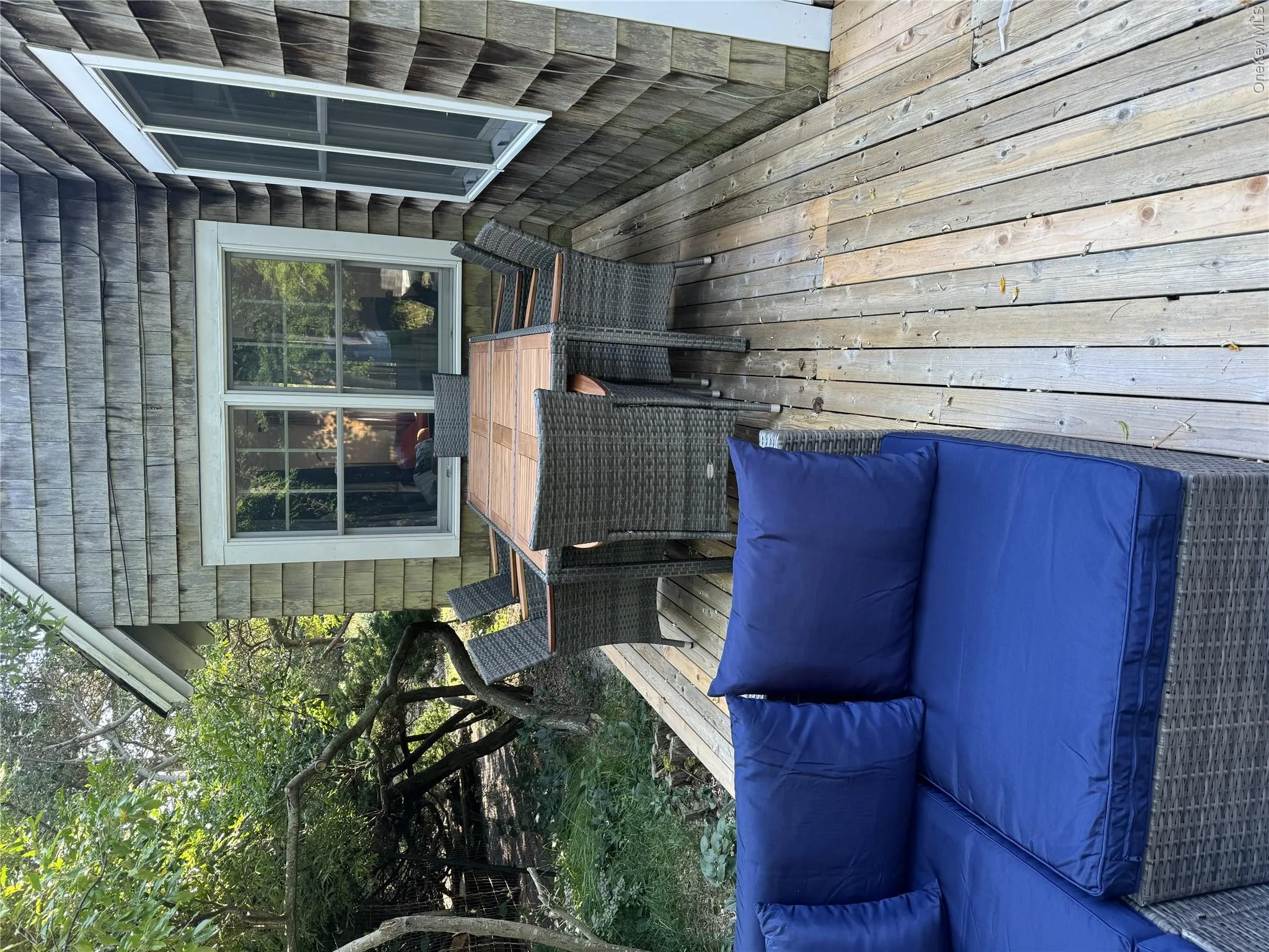 Wooden deck featuring outdoor dining space and outdoor lounge area Wooden deck featuring outdoor dining space and outdoor lounge area