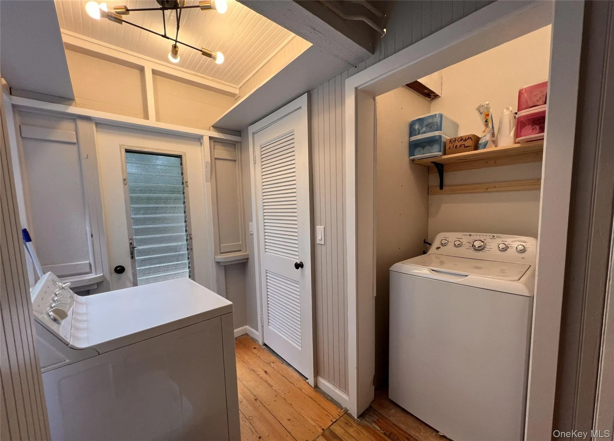 Washroom featuring washer / dryer and light wood-style floors Washroom featuring washer / dryer and light wood-style floors