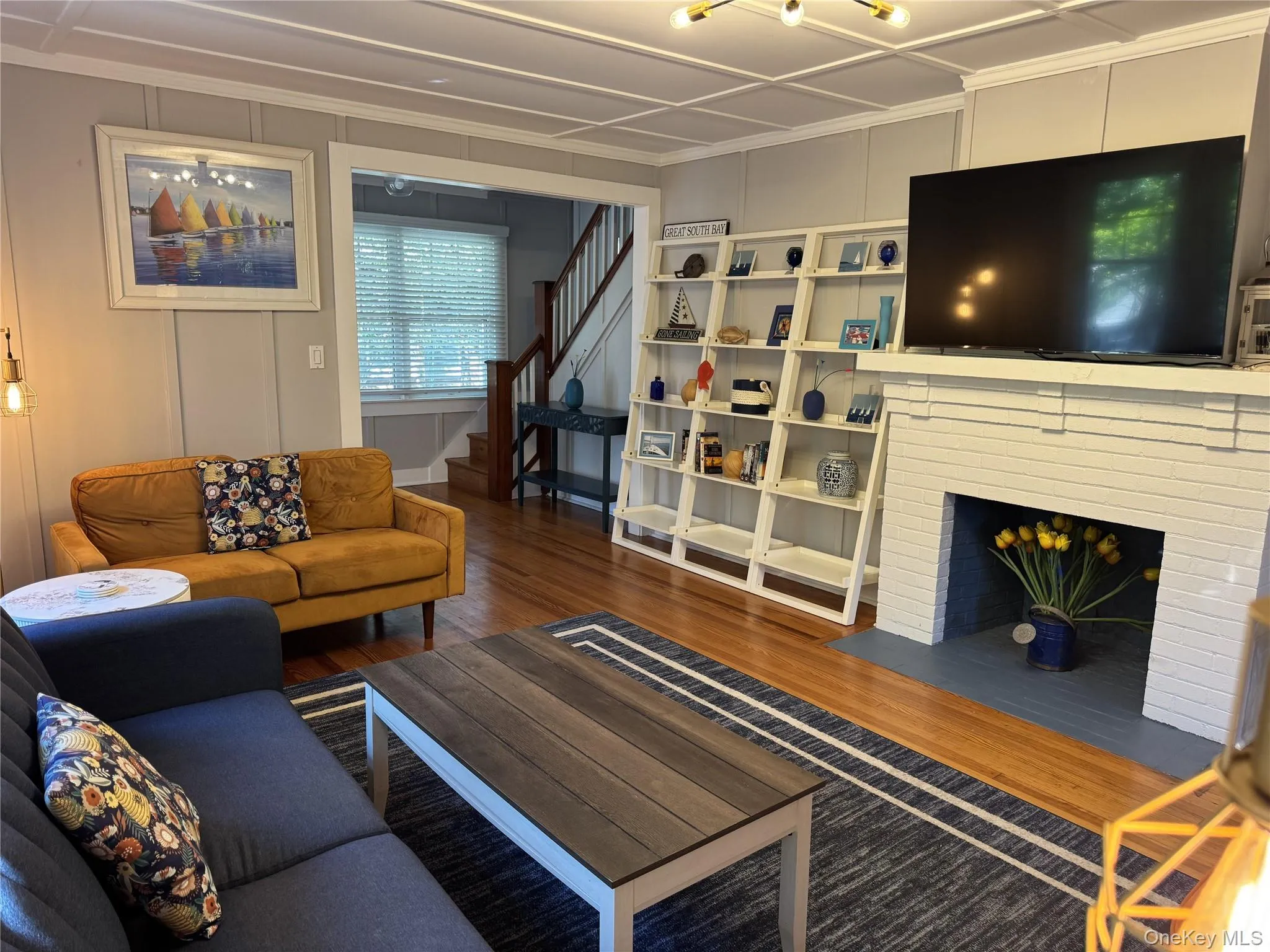 Living room featuring wood finished floors and bookcase Living room featuring wood finished floors and bookcase