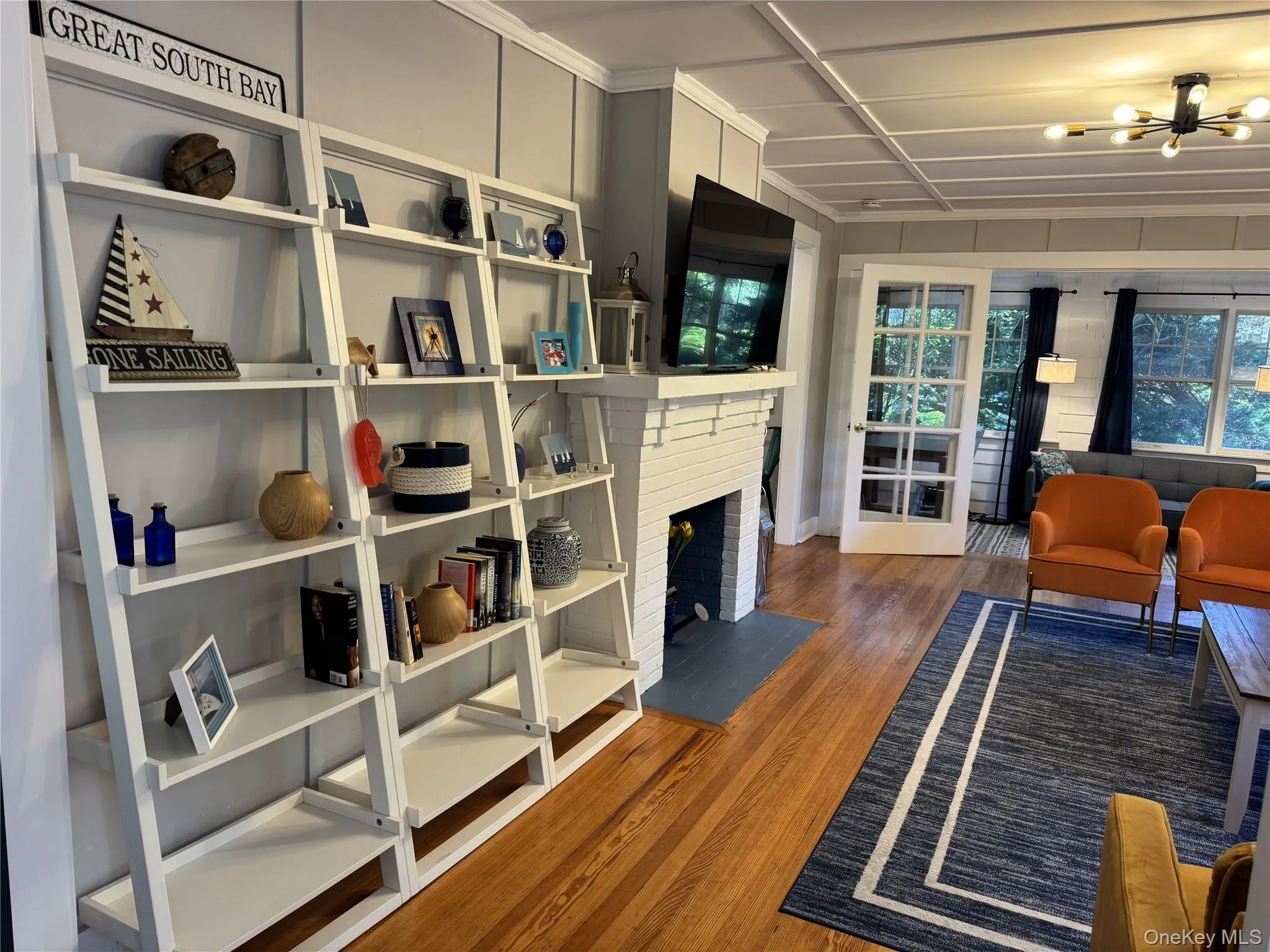 Living room featuring wood finished floors and bookcase Living room featuring wood finished floors and bookcase