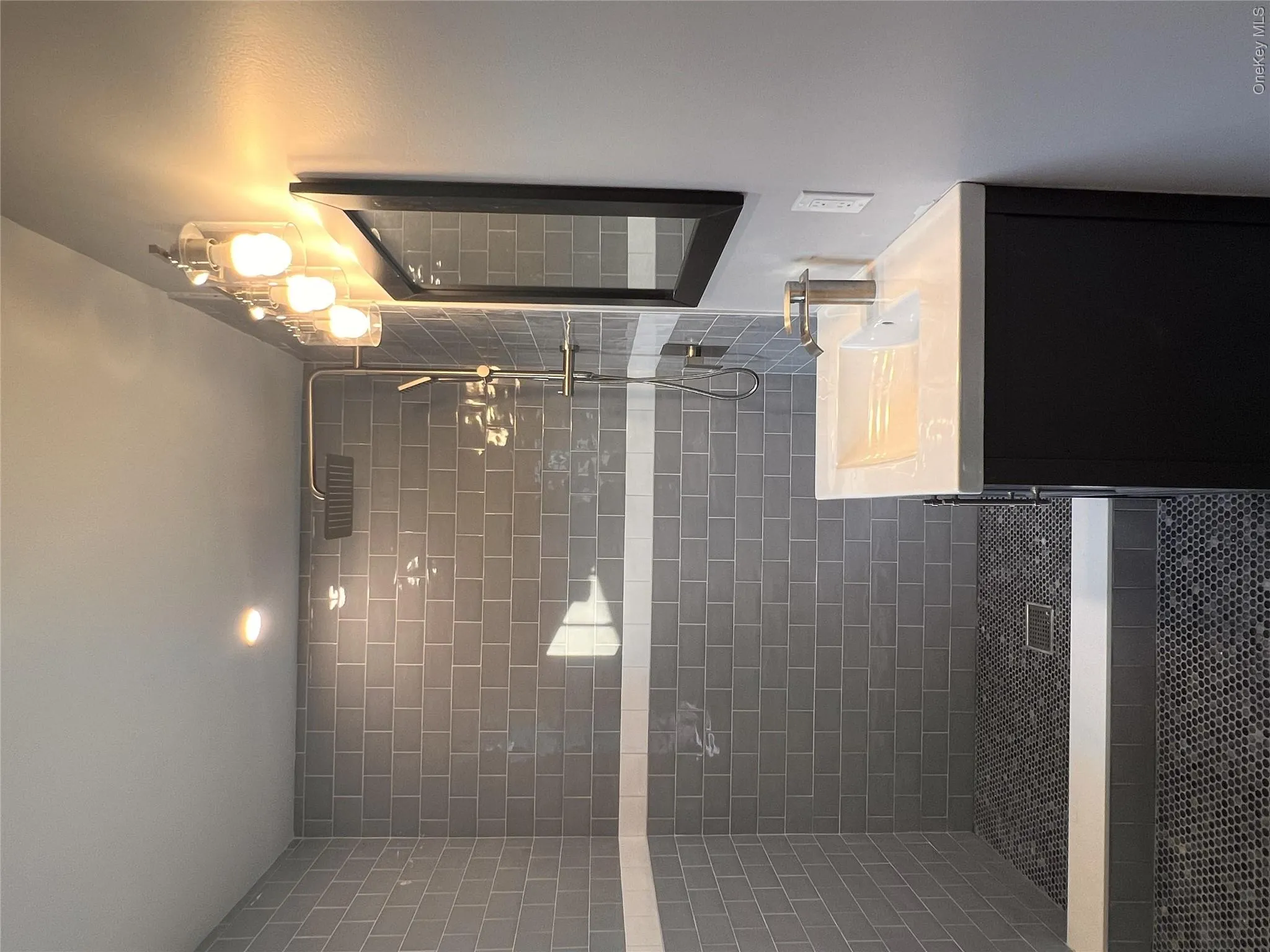 Full bathroom with tiled shower and vanity Full bathroom with tiled shower and vanity
