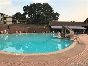 Community pool featuring a water slide Community pool featuring a water slide