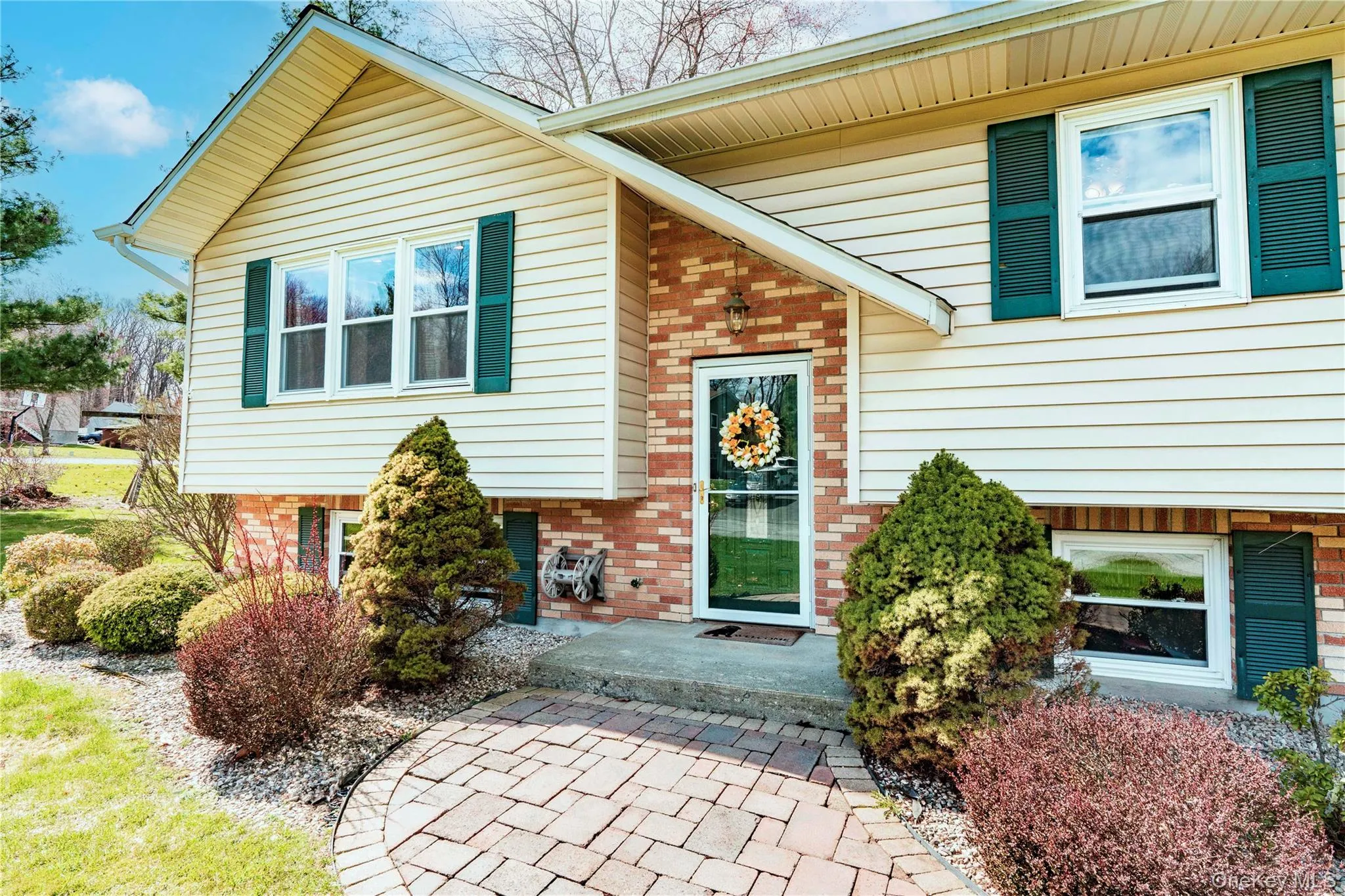 Beautifully landscaped home with paver walkway Beautifully landscaped home with paver walkway