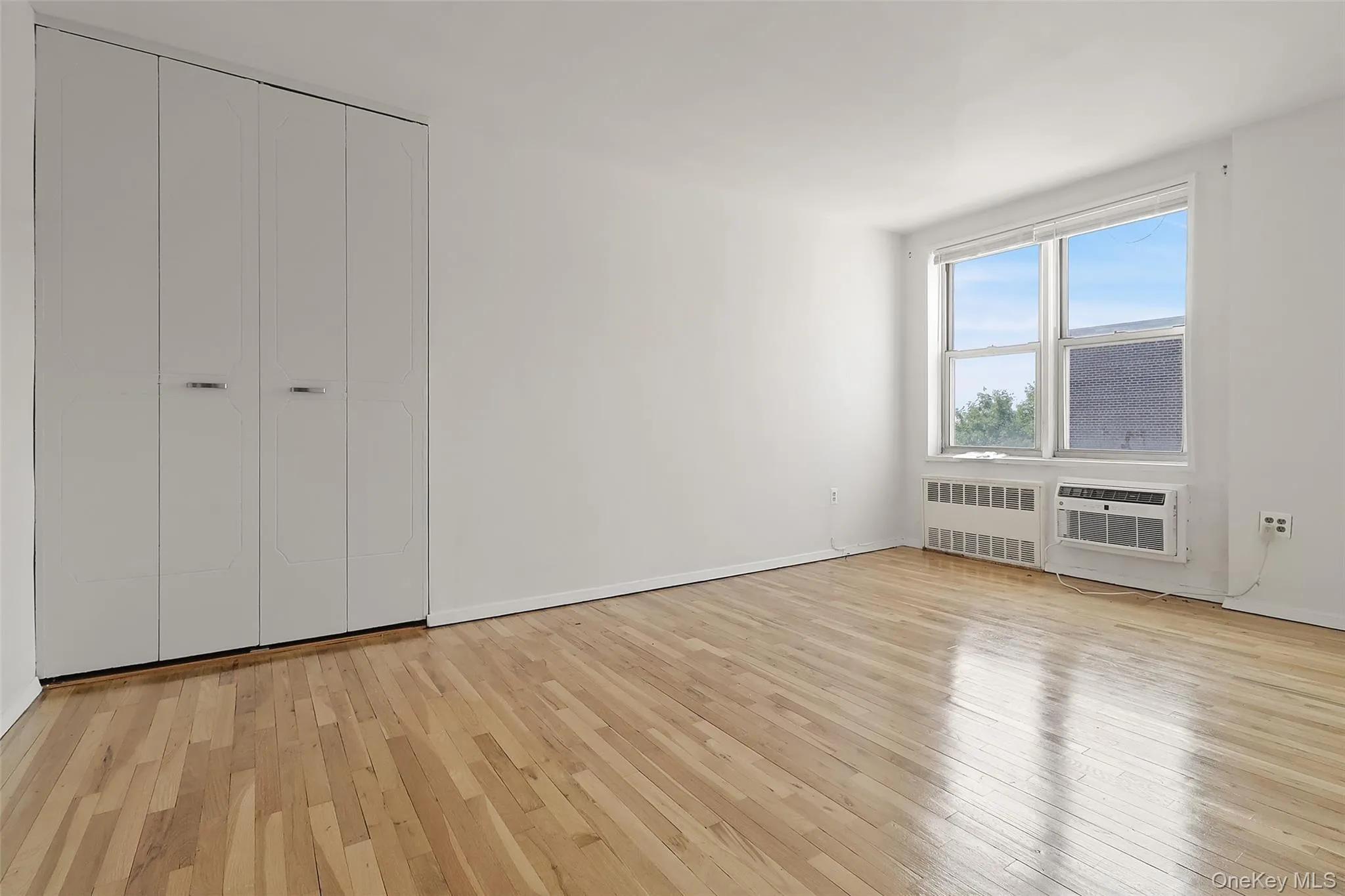 Bedroom with hardwood floors, new AC unit and views of Long Island Sound Bedroom with hardwood floors, new AC unit and views of Long Island Sound