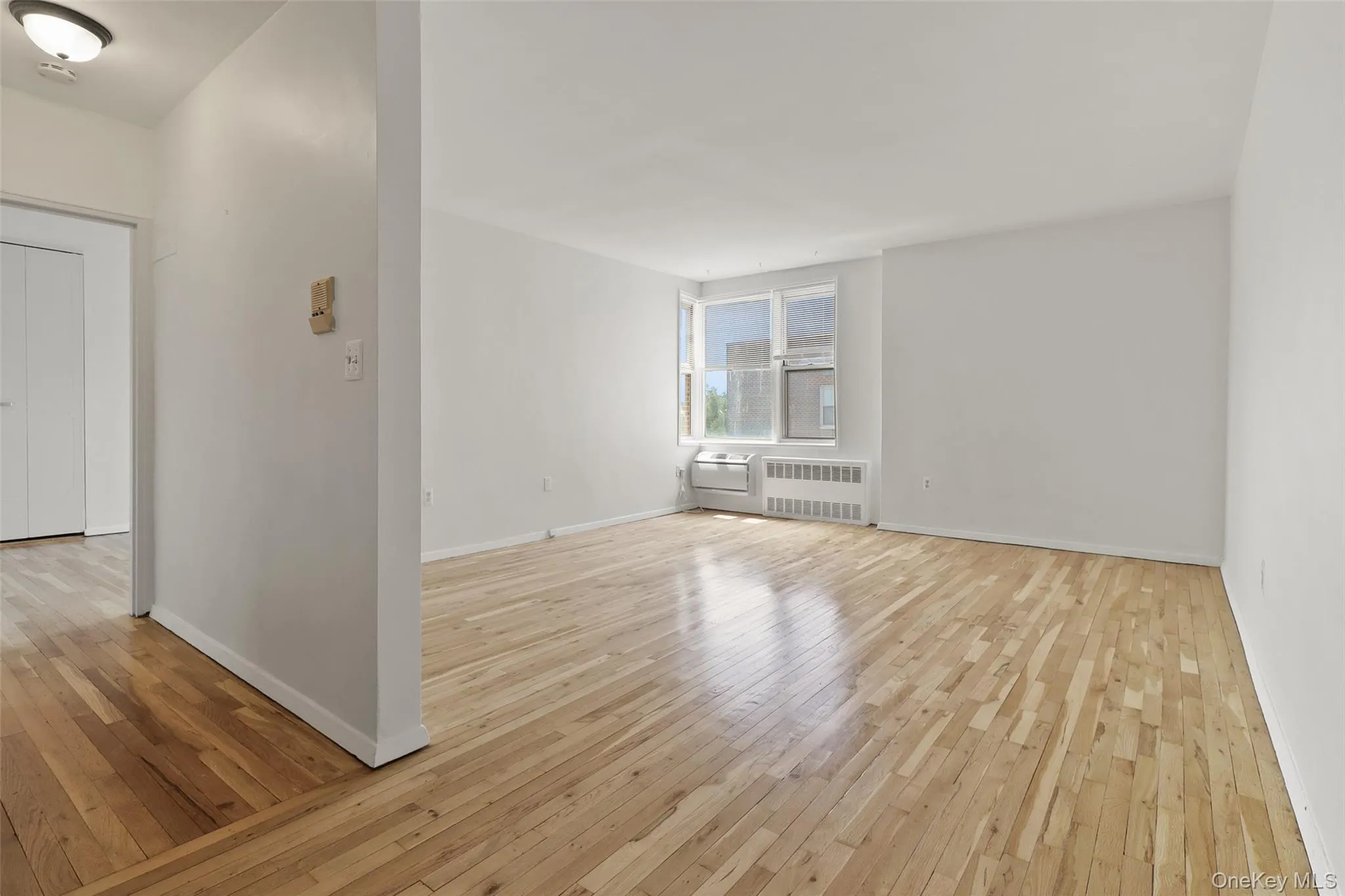 Living room with hardwood floors and view of Long Island Sound Living room with hardwood floors and view of Long Island Sound