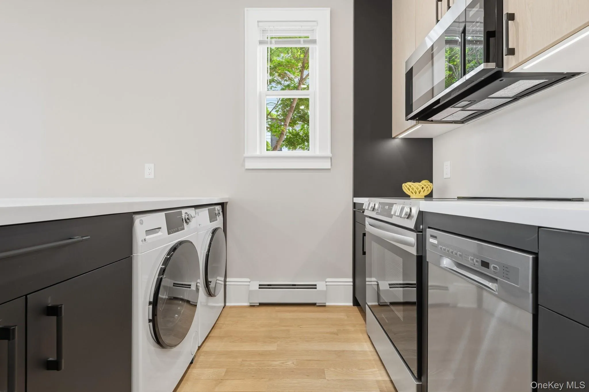 Facing the living area, you can see the undercounter washer and dryer.conveniently located out of sight in the contemporary kitchen. Facing the living area, you can see the undercounter washer and dryer.conveniently located out of sight in the contemporary kitchen.