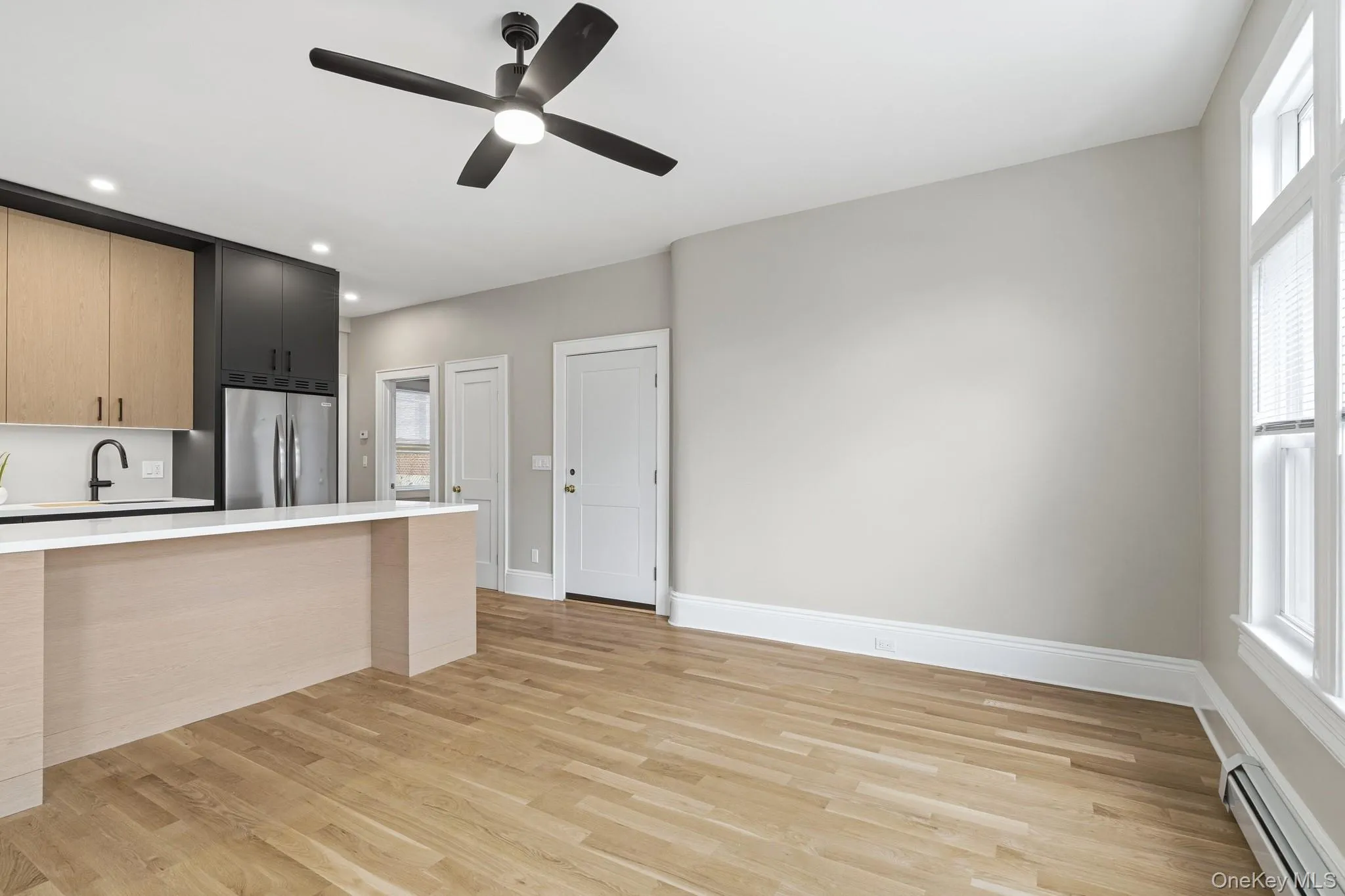 Open concept living room and kitchen features stunning wood floors, bar and breakast nook, galley chef's kitchen. Open concept living room and kitchen features stunning wood floors, bar and breakast nook, galley chef's kitchen.