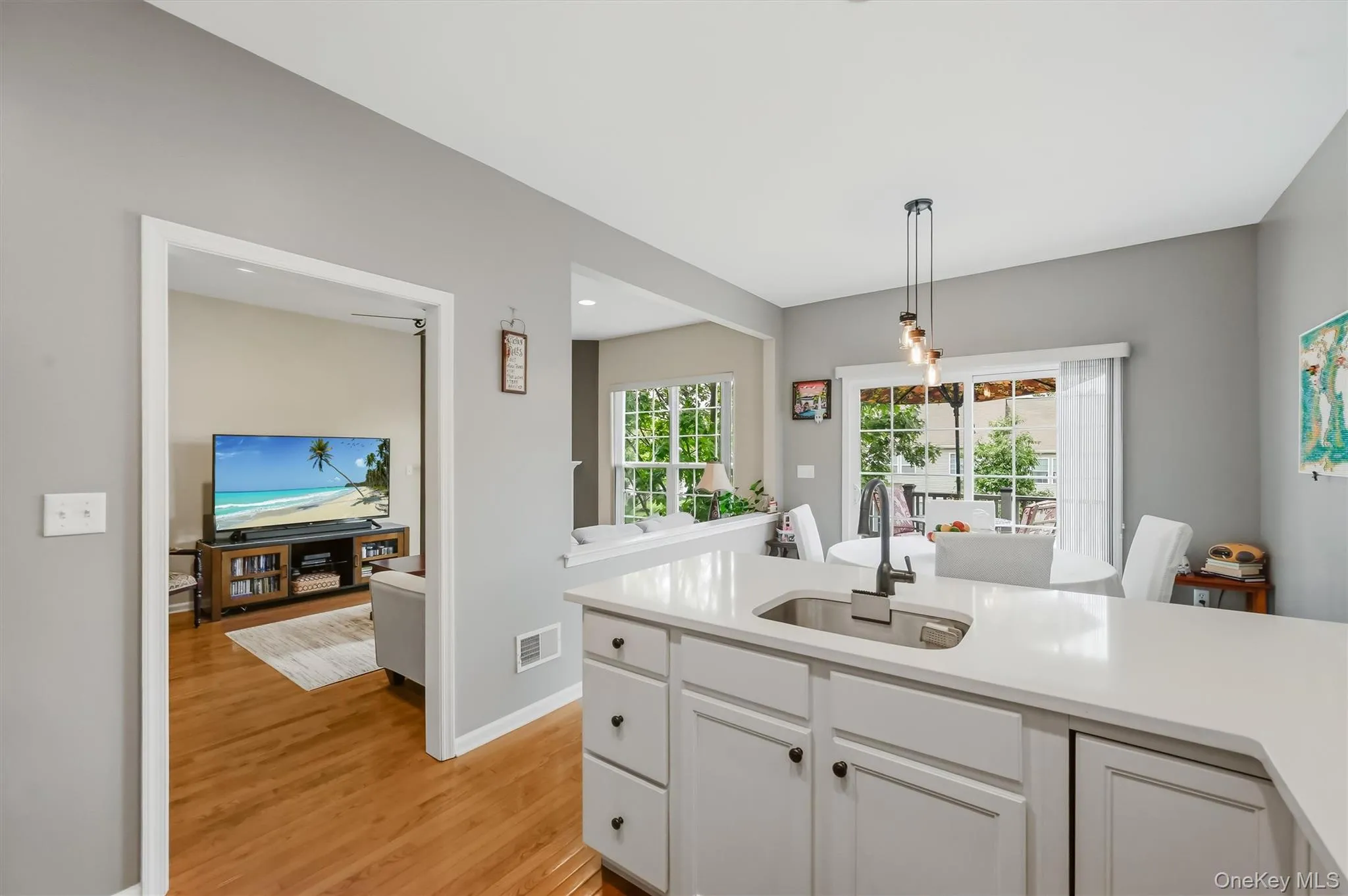 The kitchen features quartz counters with a soft marshmallow glazed cabinets. The kitchen features quartz counters with a soft marshmallow glazed cabinets.