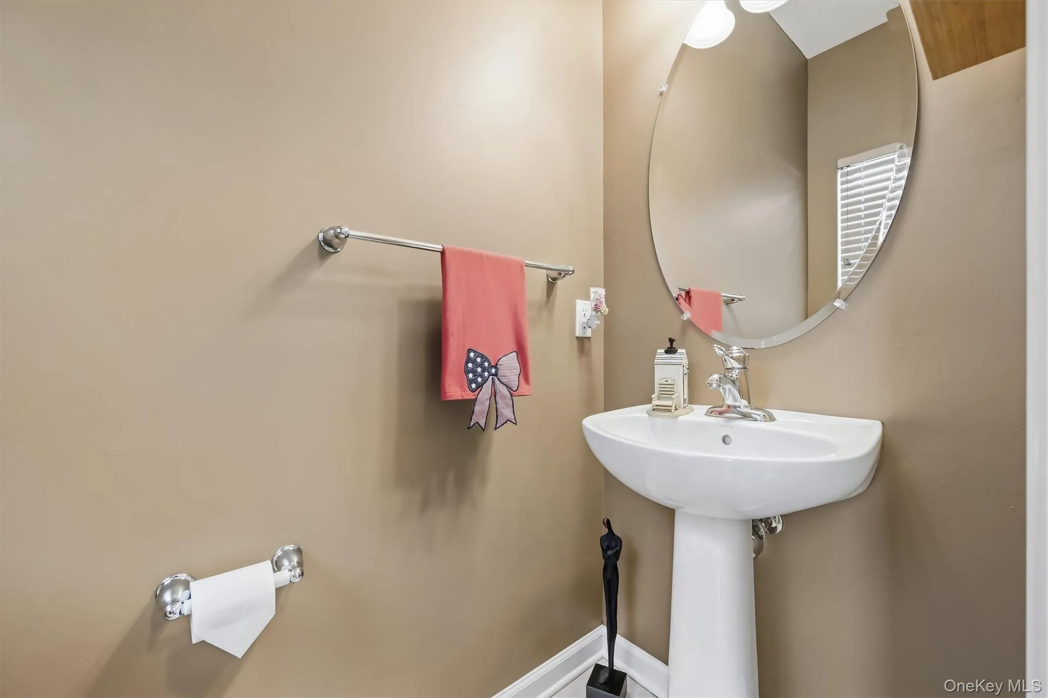The powder room offers a sleek pedestal sink. The powder room offers a sleek pedestal sink.