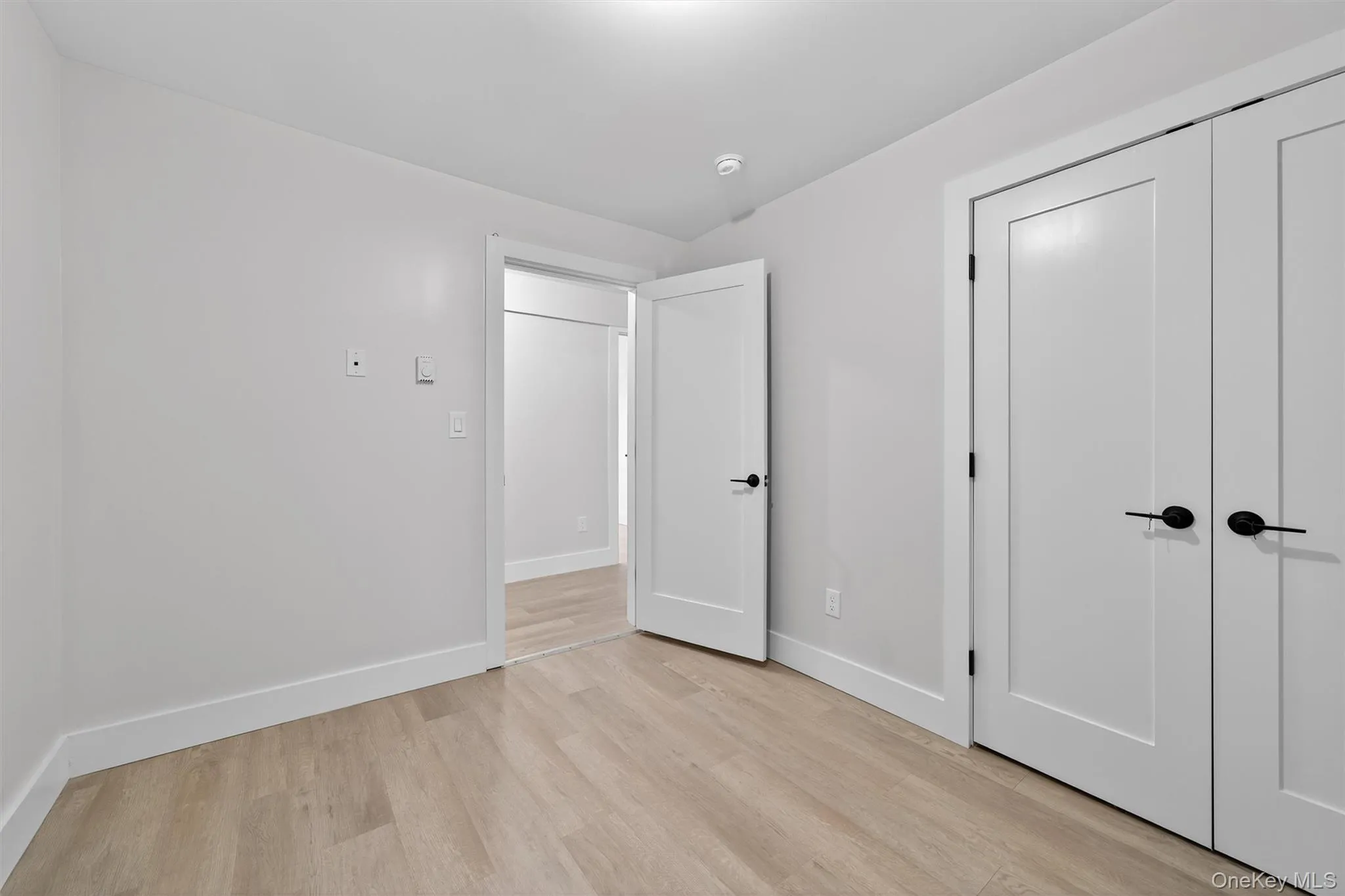 Unfurnished bedroom with light wood-style flooring and a closet Unfurnished bedroom with light wood-style flooring and a closet