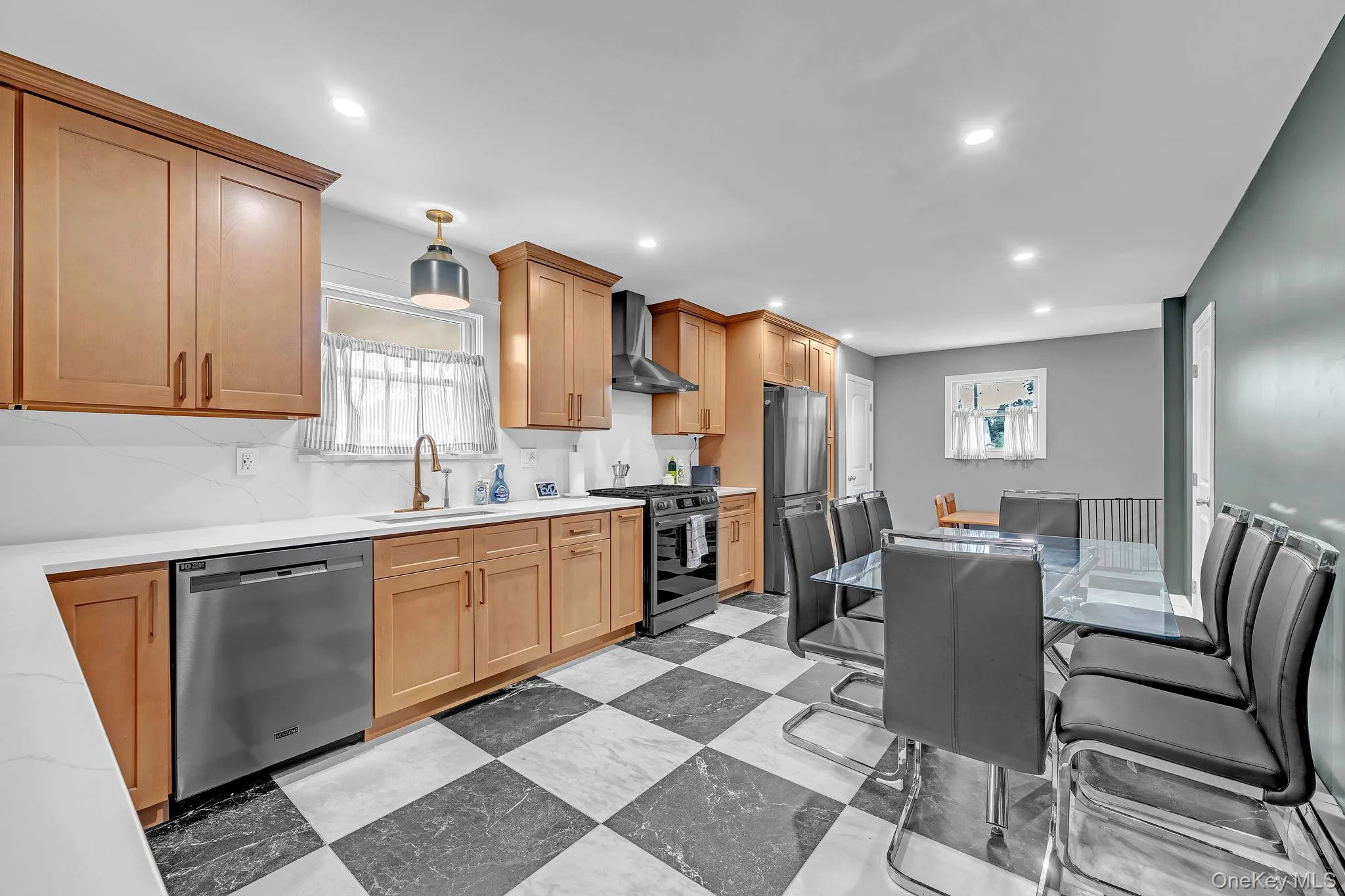 Kitchen featuring checkered flooring, recessed lighting, wood-finish cabinetry, a white countertop, and stainless steel appliances Kitchen featuring checkered flooring, recessed lighting, wood-finish cabinetry, a white countertop, and stainless steel appliances