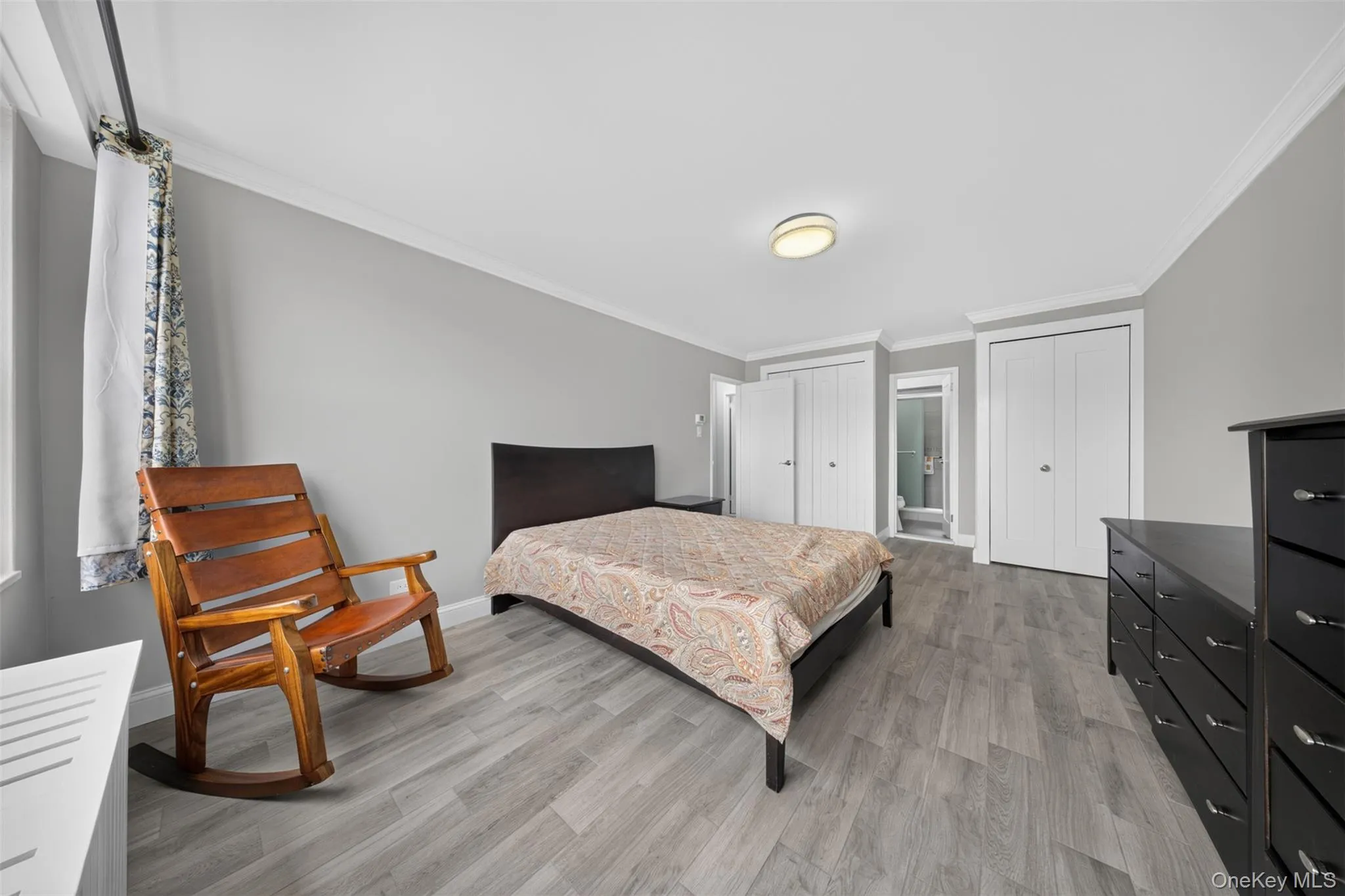 Bright primary bedroom with oversized windows dual closets and en-suite full bathroom Bright primary bedroom with oversized windows dual closets and en-suite full bathroom
