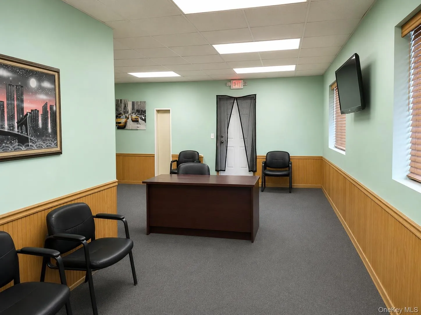 Reception area featuring beadboard wainscoting and light green walls Reception area featuring beadboard wainscoting and light green walls