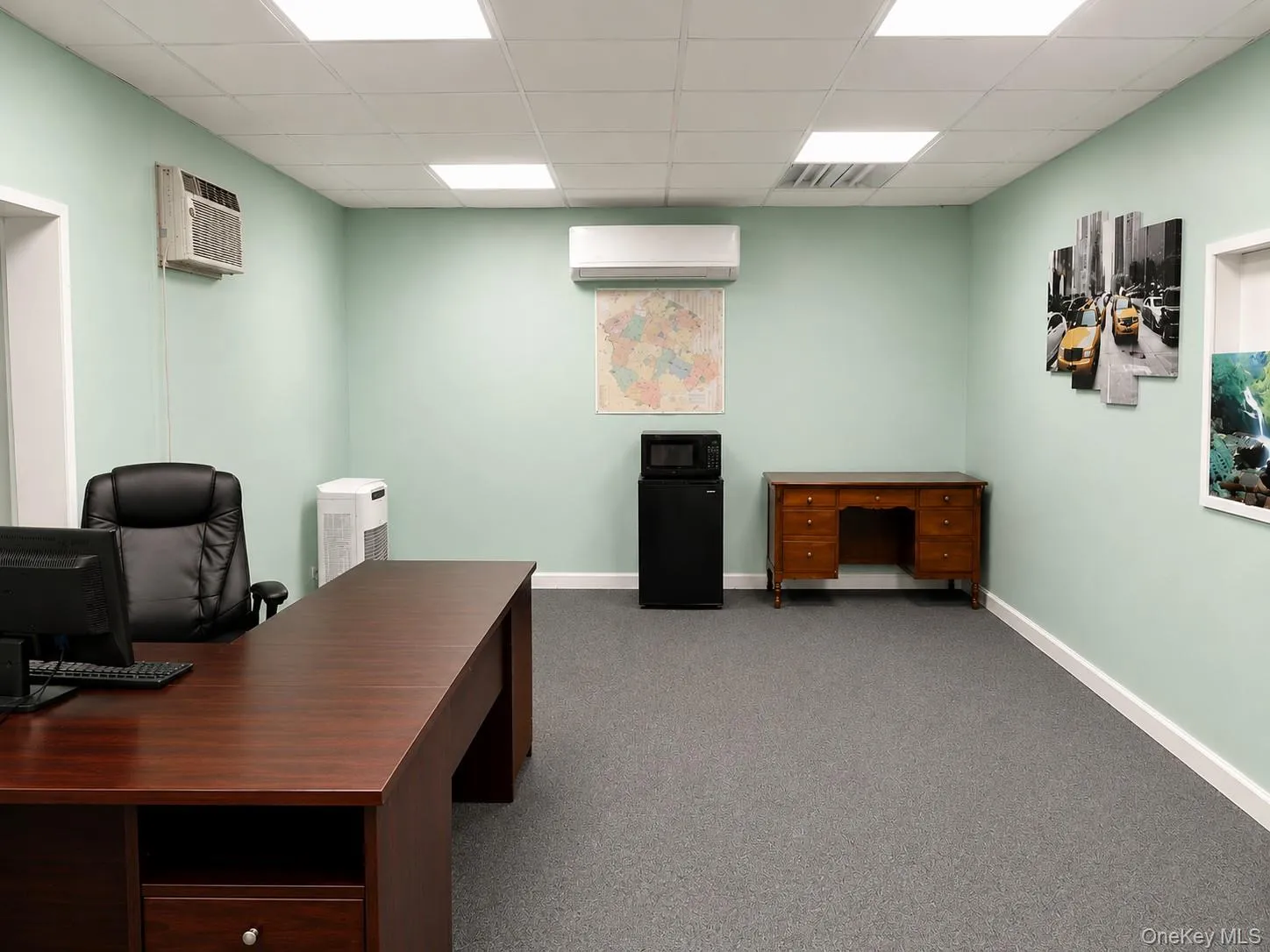 Spacious room with light green walls and grey carpeting Spacious room with light green walls and grey carpeting