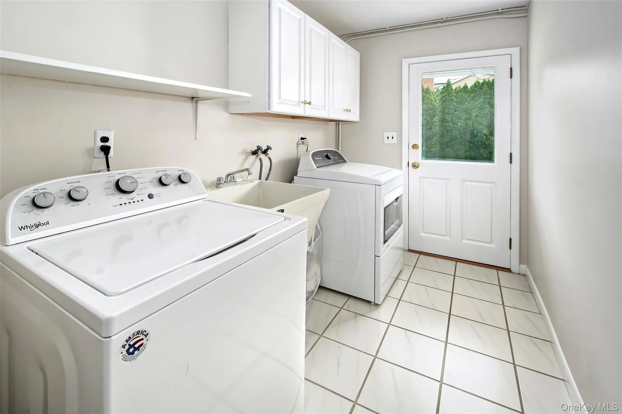 Sizable laundry area with side door entrance and endless possibilities. Sizable laundry area with side door entrance and endless possibilities.
