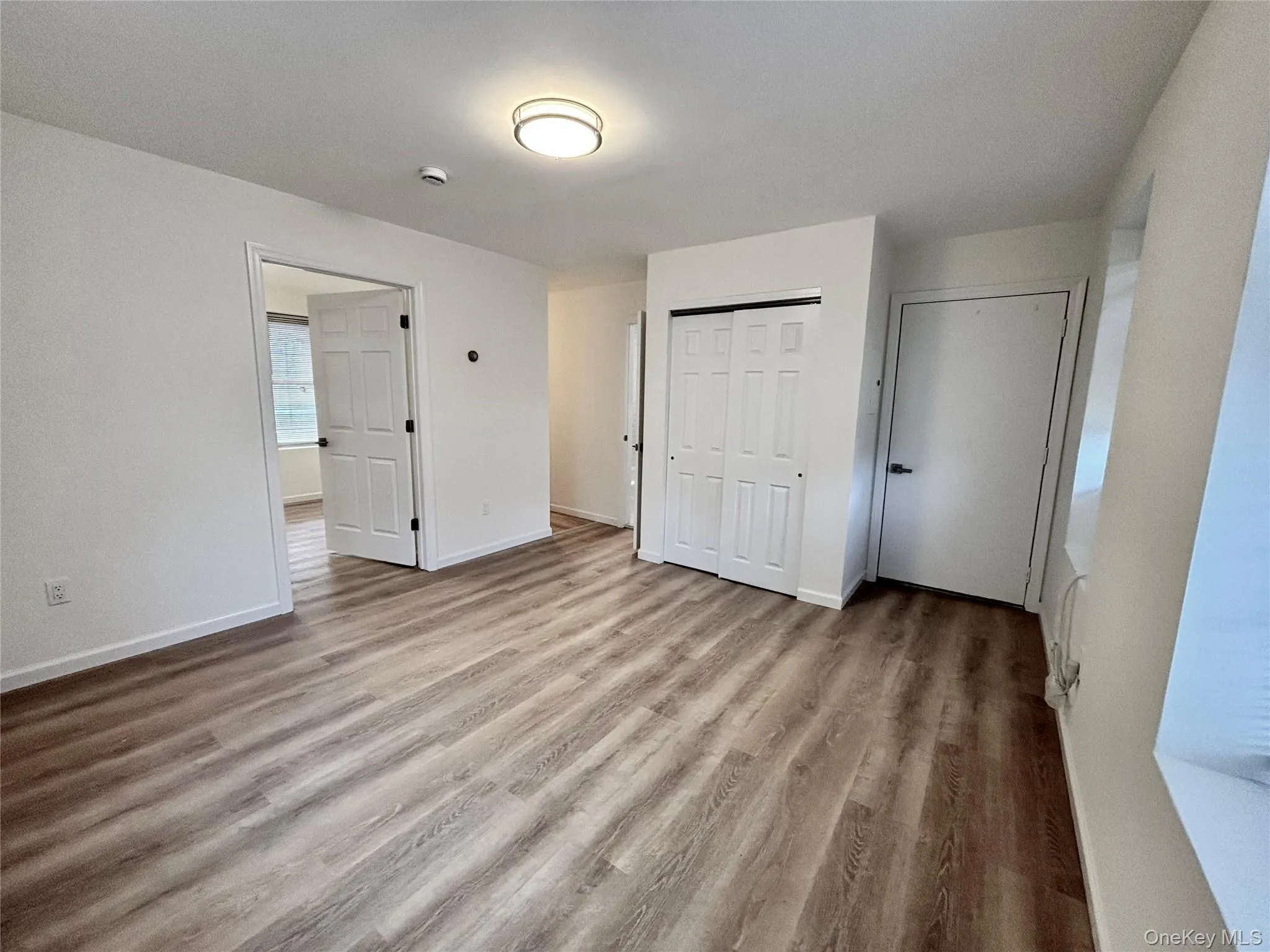 Unfurnished bedroom featuring wood finished floors and baseboards Unfurnished bedroom featuring wood finished floors and baseboards