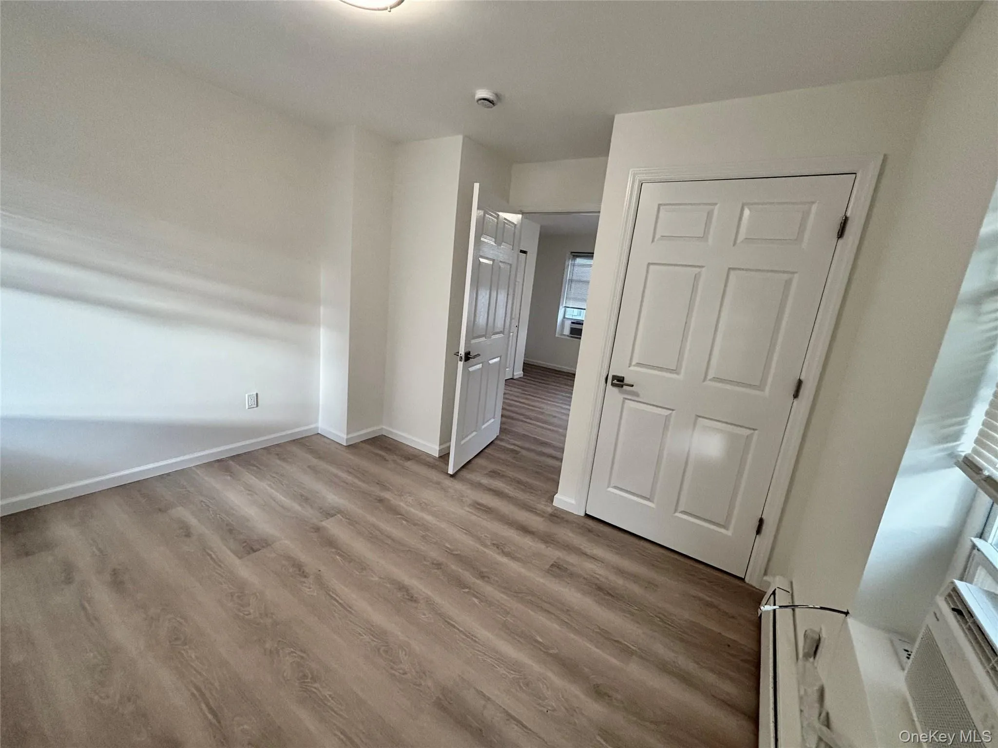 Unfurnished bedroom featuring light wood finished floors and baseboards Unfurnished bedroom featuring light wood finished floors and baseboards