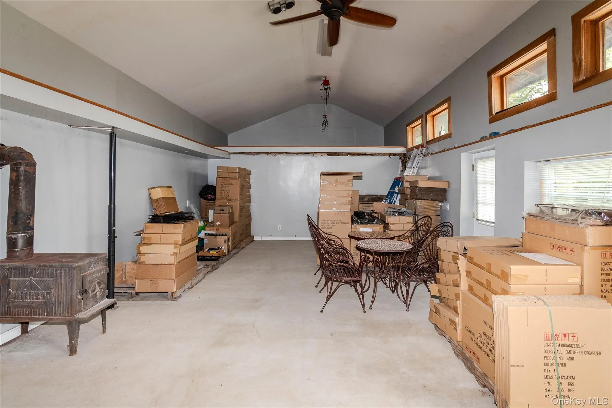 View of interior of warehouse with woodburning stove and newer windows View of interior of warehouse with woodburning stove and newer windows