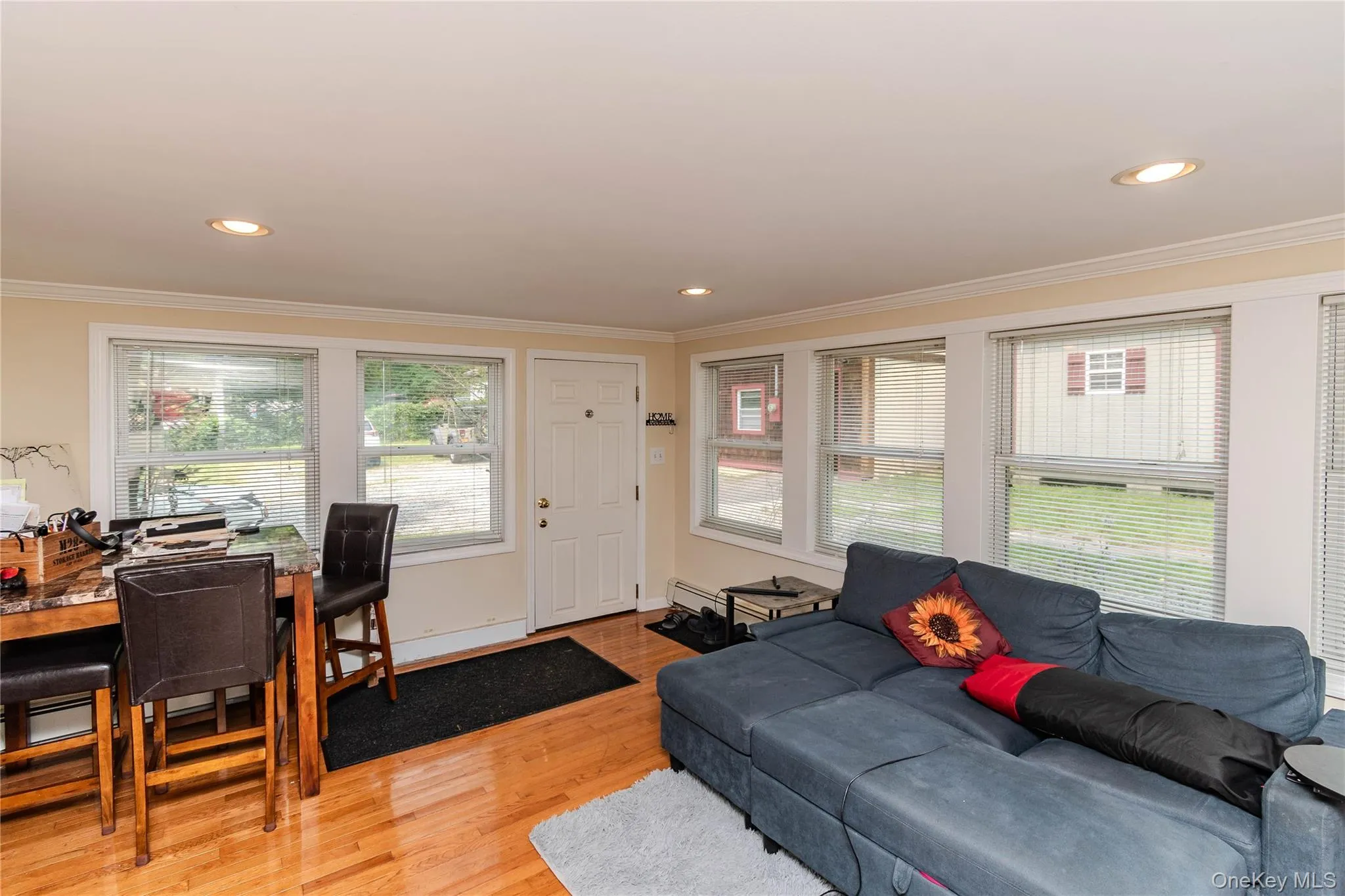 Living room of main house with hardwood floors, recess lighting and walls of windows. Living room of main house with hardwood floors, recess lighting and walls of windows.