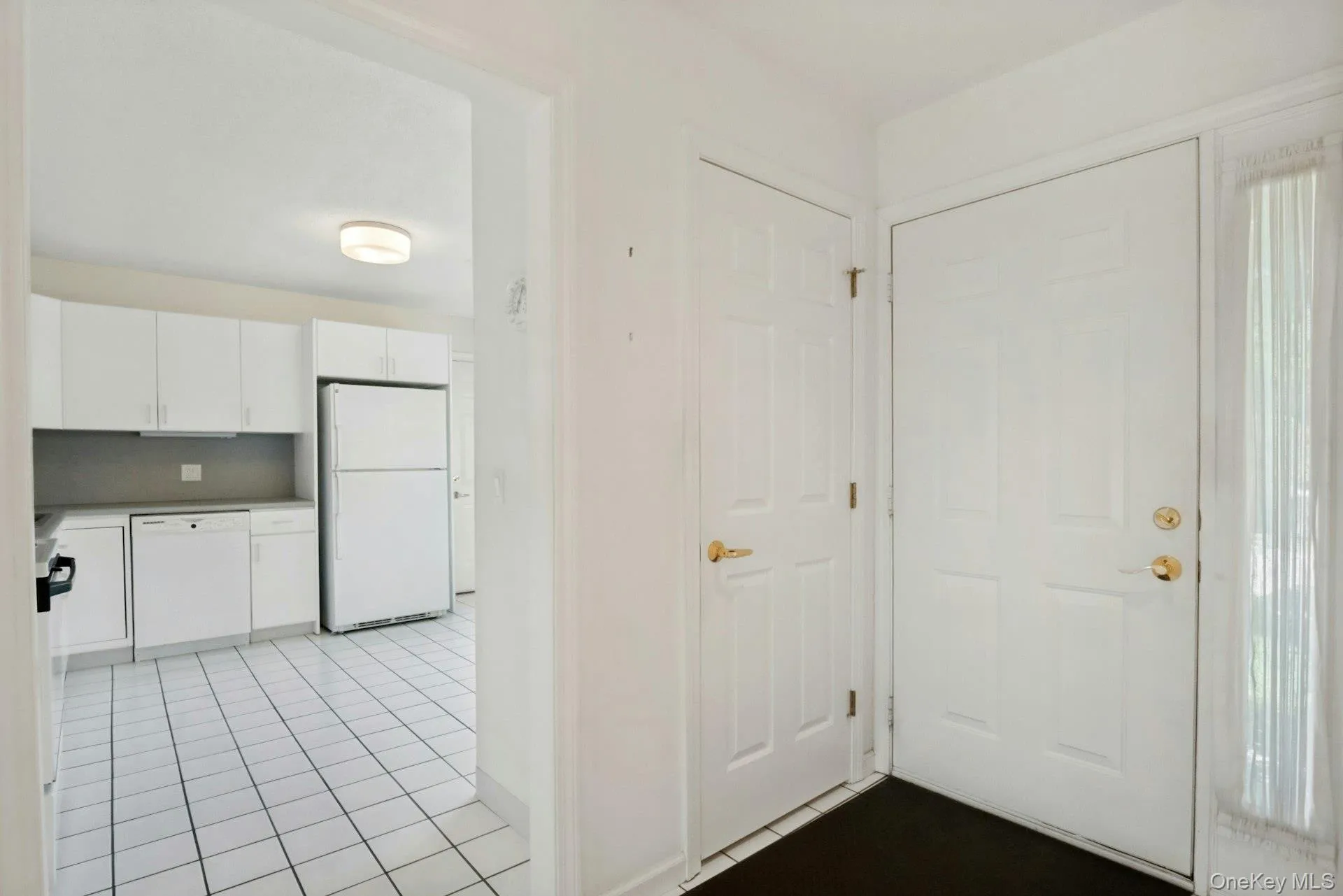 Entrance Foyer with coat closet and white tiled floor Entrance Foyer with coat closet and white tiled floor