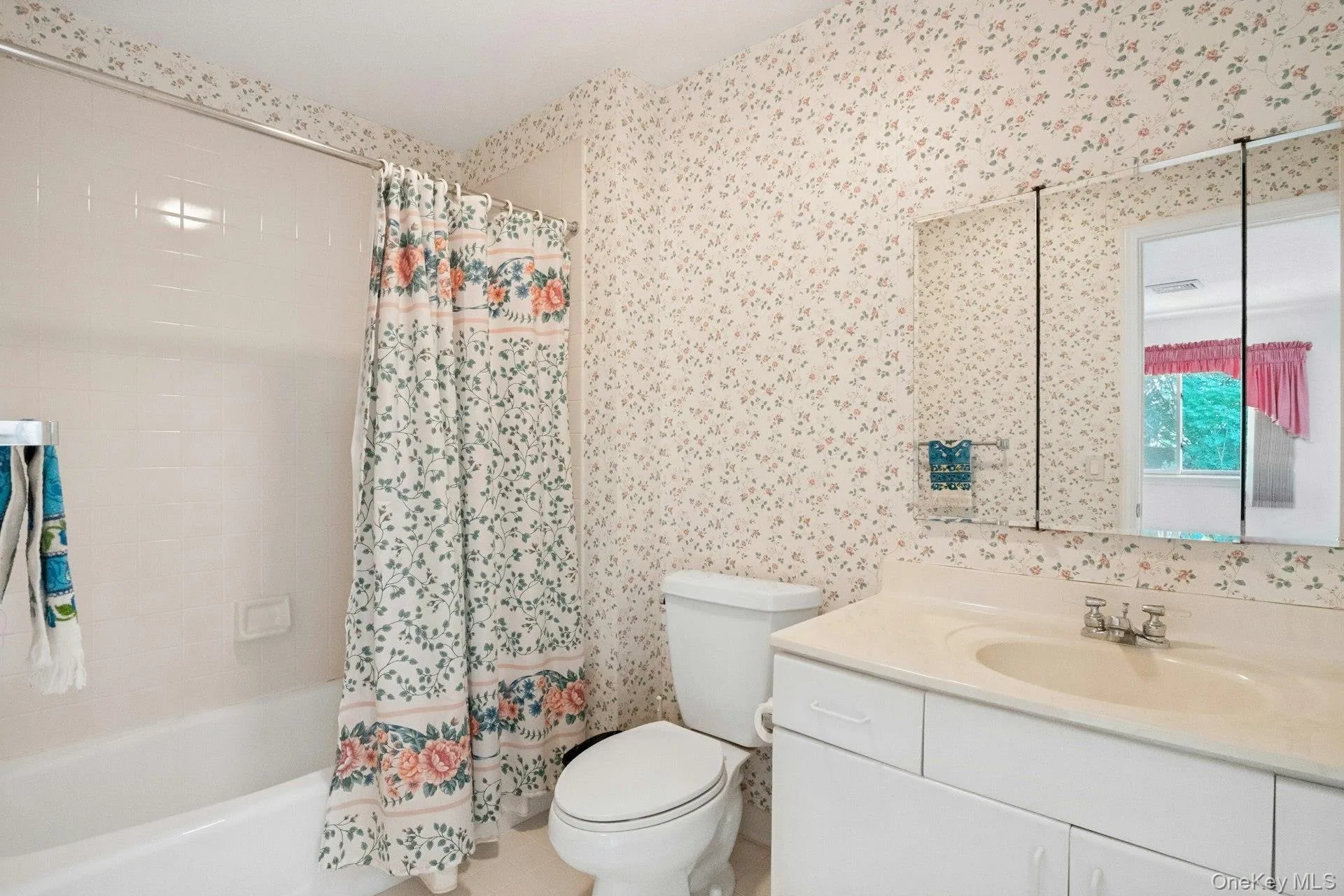 Ensuite primary bathroom with tub & triple mirrored vanity Ensuite primary bathroom with tub & triple mirrored vanity