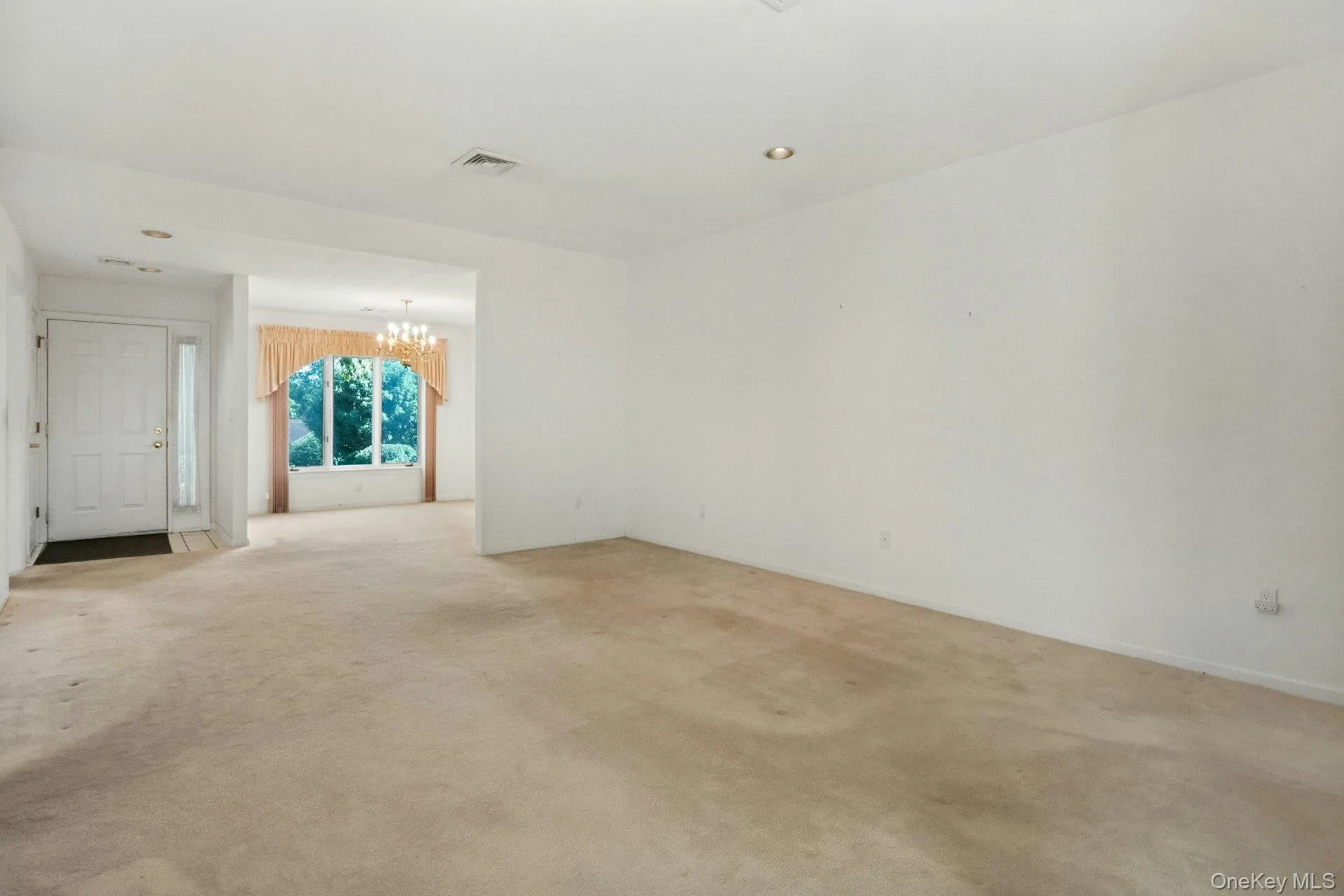 Long view of the living room to the dining area, & entry hall Long view of the living room to the dining area, & entry hall